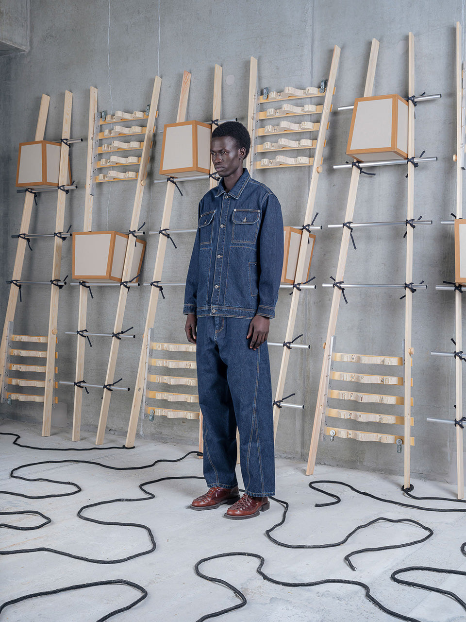 Model wearing Amphi Pants in Rinse Denim by Henrik Vibskov side view