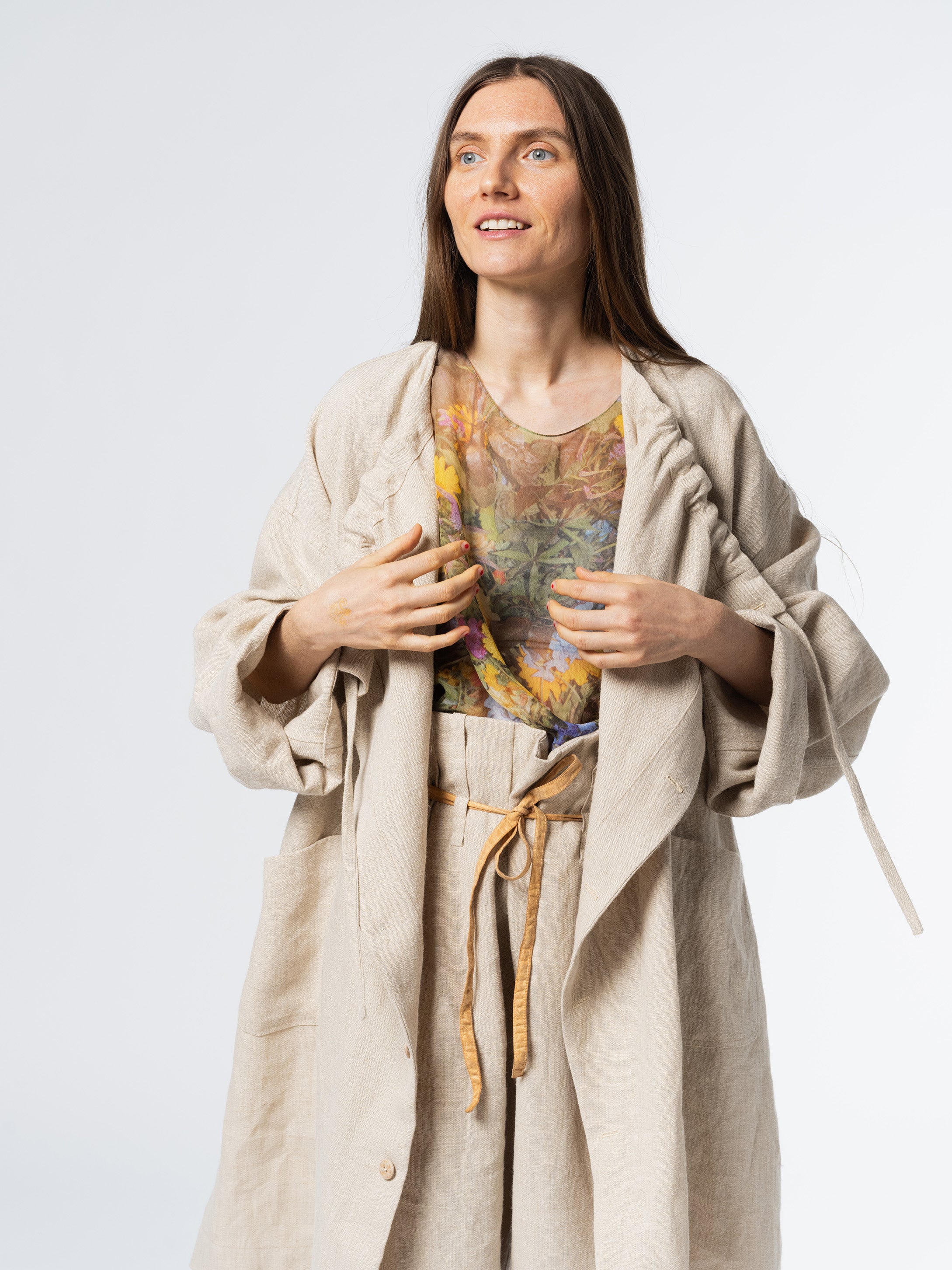 Close-up of the Anntian Trench Jacket Hemp in Natural, showing the adjustable drawstring neckline and off-white hemp fabric texture