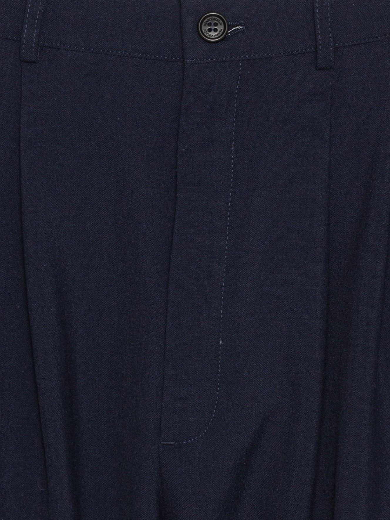 Close-up of Henrik Vibskov Ants Pants in Dark Navy highlighting the pleated front and fabric texture.