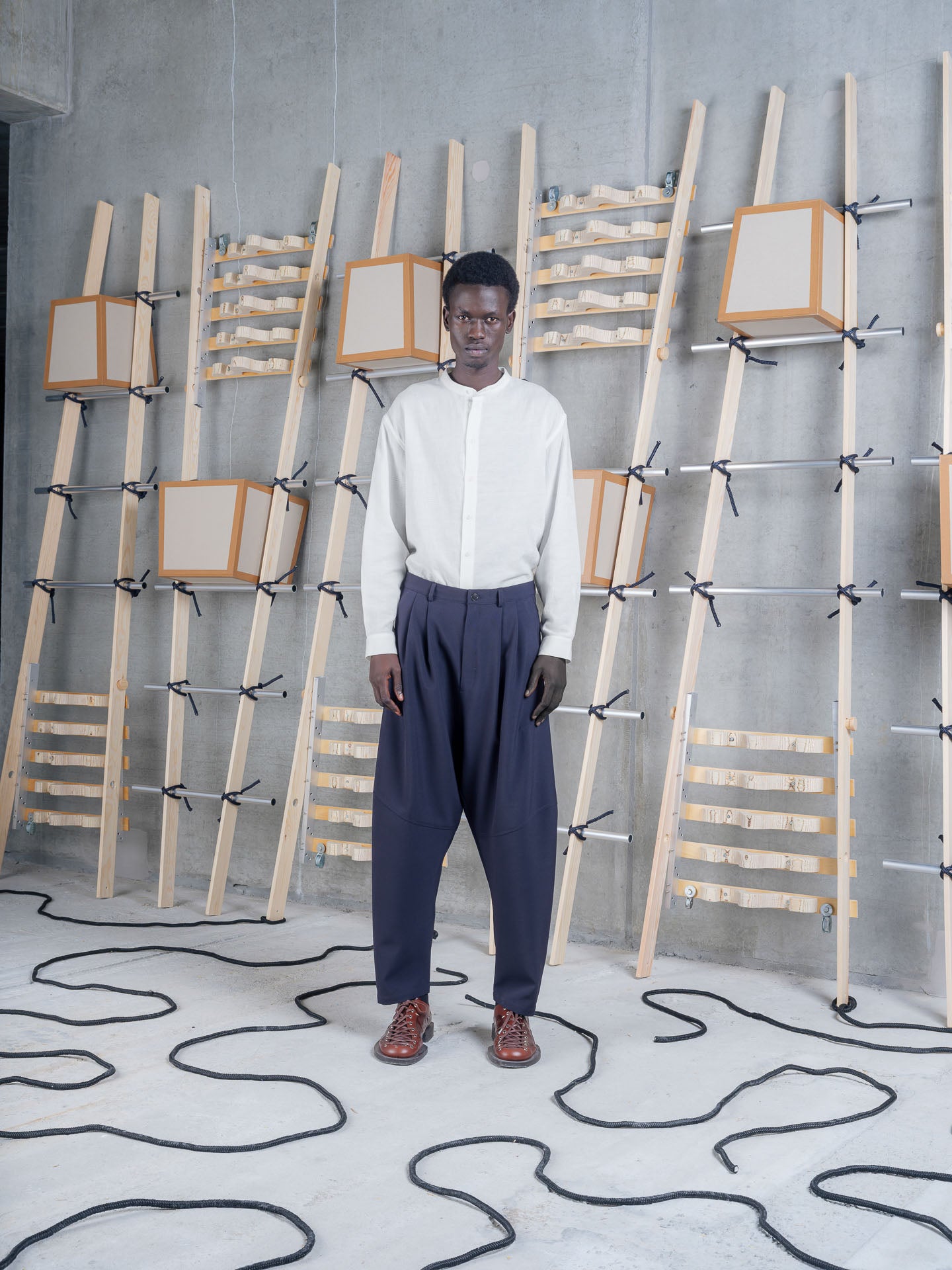 Henrik Vibskov Ants Pants in Dark Navy worn with a white shirt, front view.