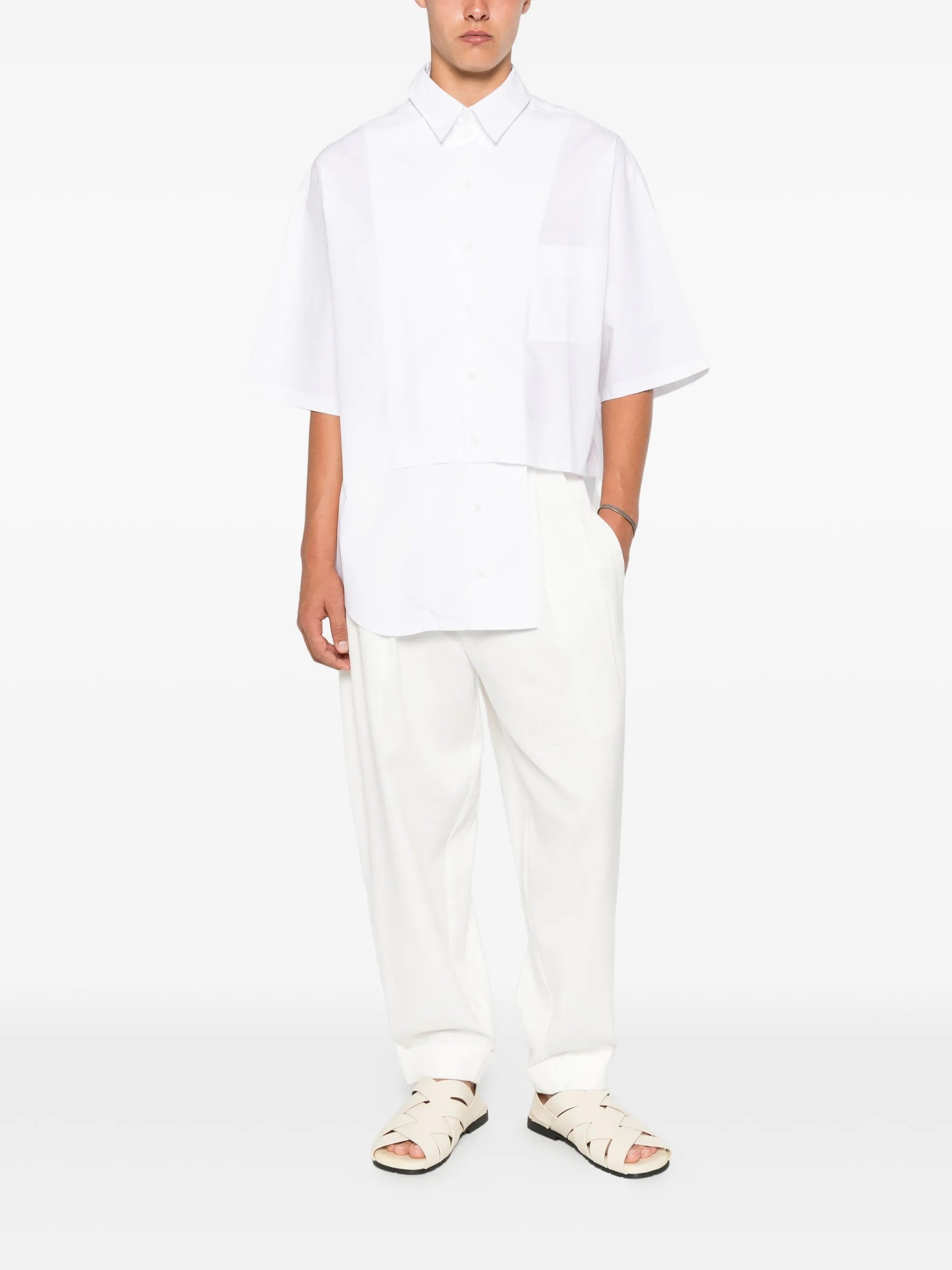 House Of The Very Islands Blake Trousers in Off White - full length front view on model showing relaxed fit and pleat details