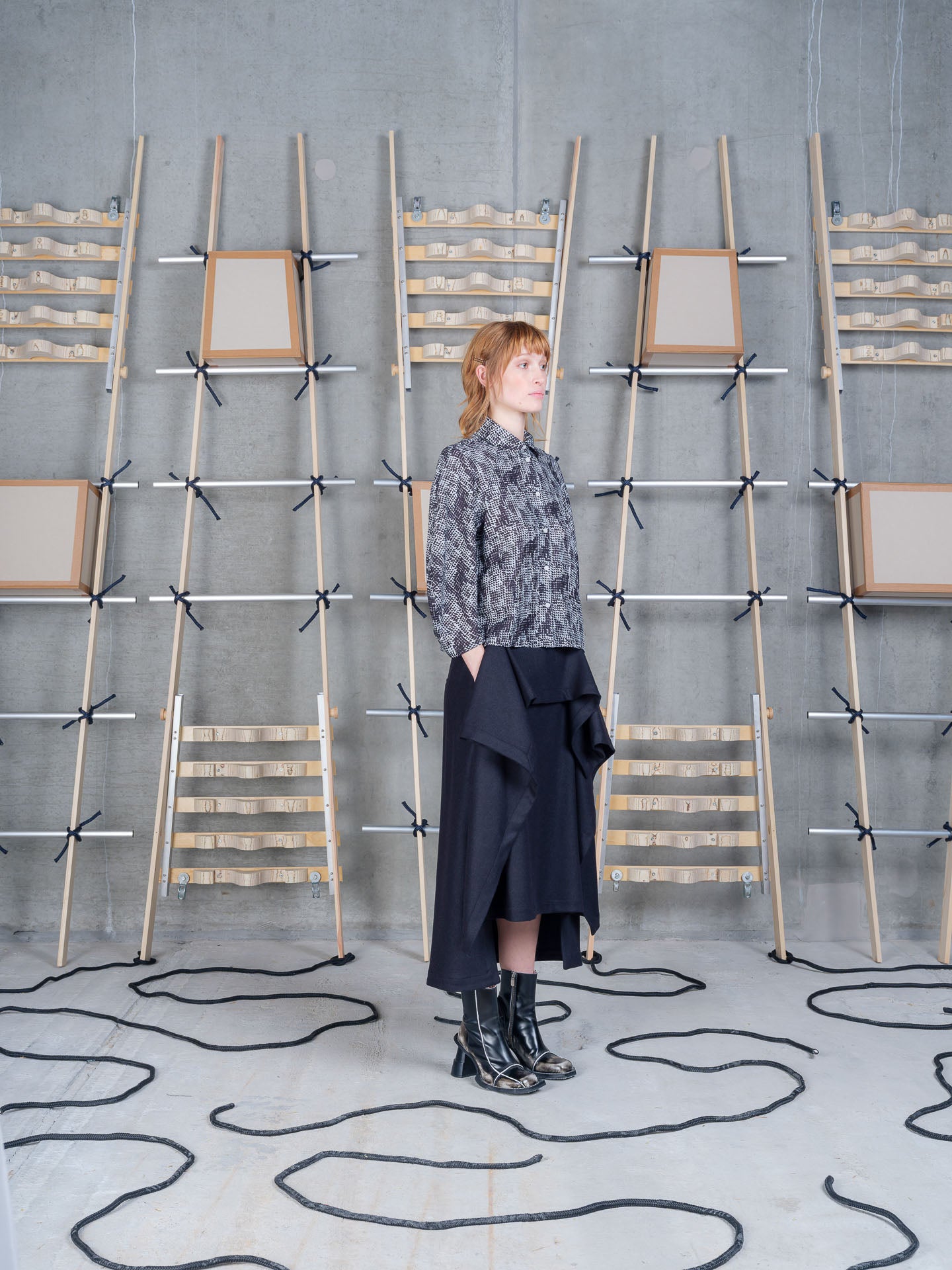 Model wearing Blanket Skirt in Blue Wool Checks by Henrik Vibskov three-quarter view
