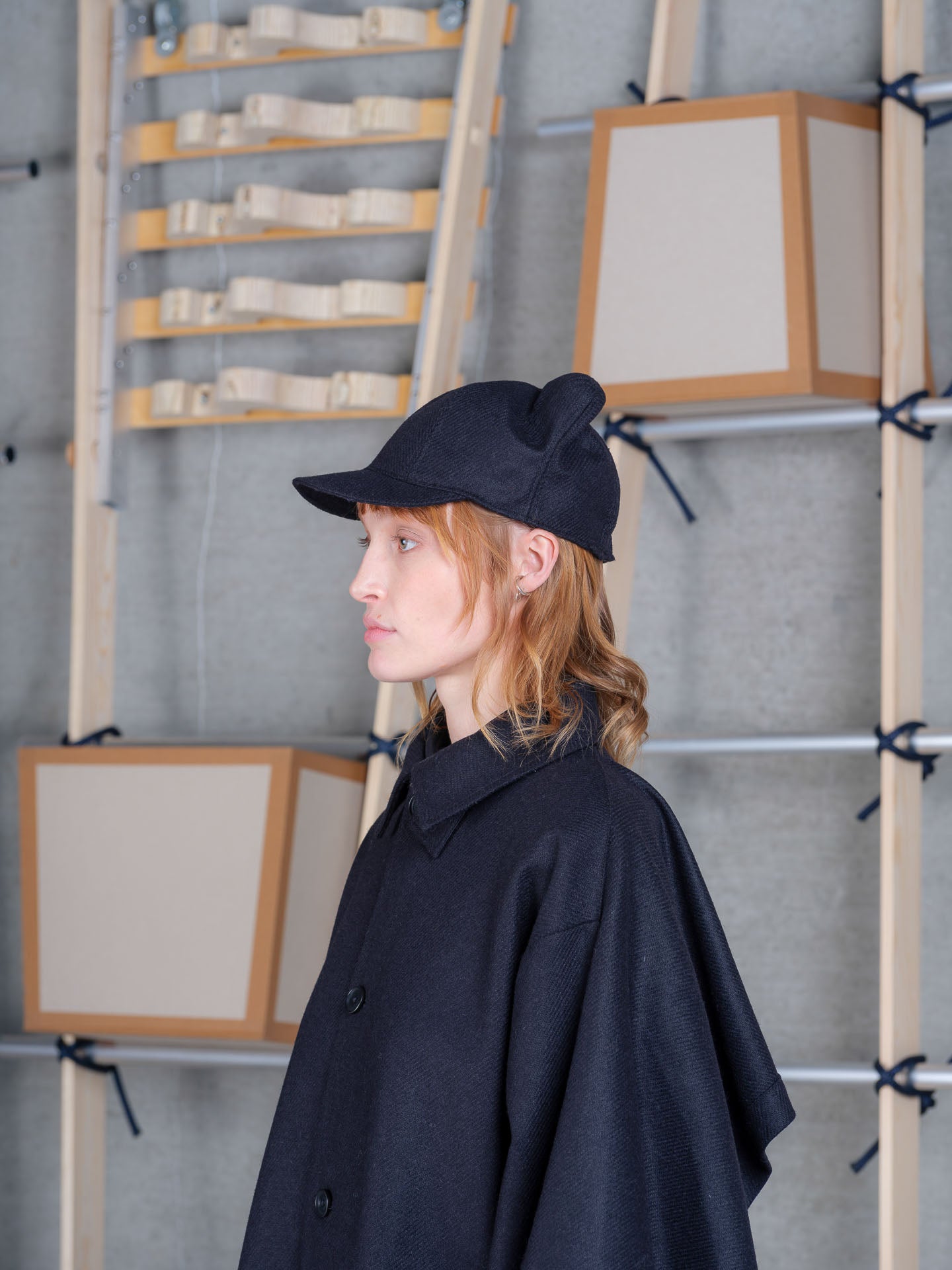 Model wearing Cara Eyed Cap in Black by Henrik Vibskov profile view
