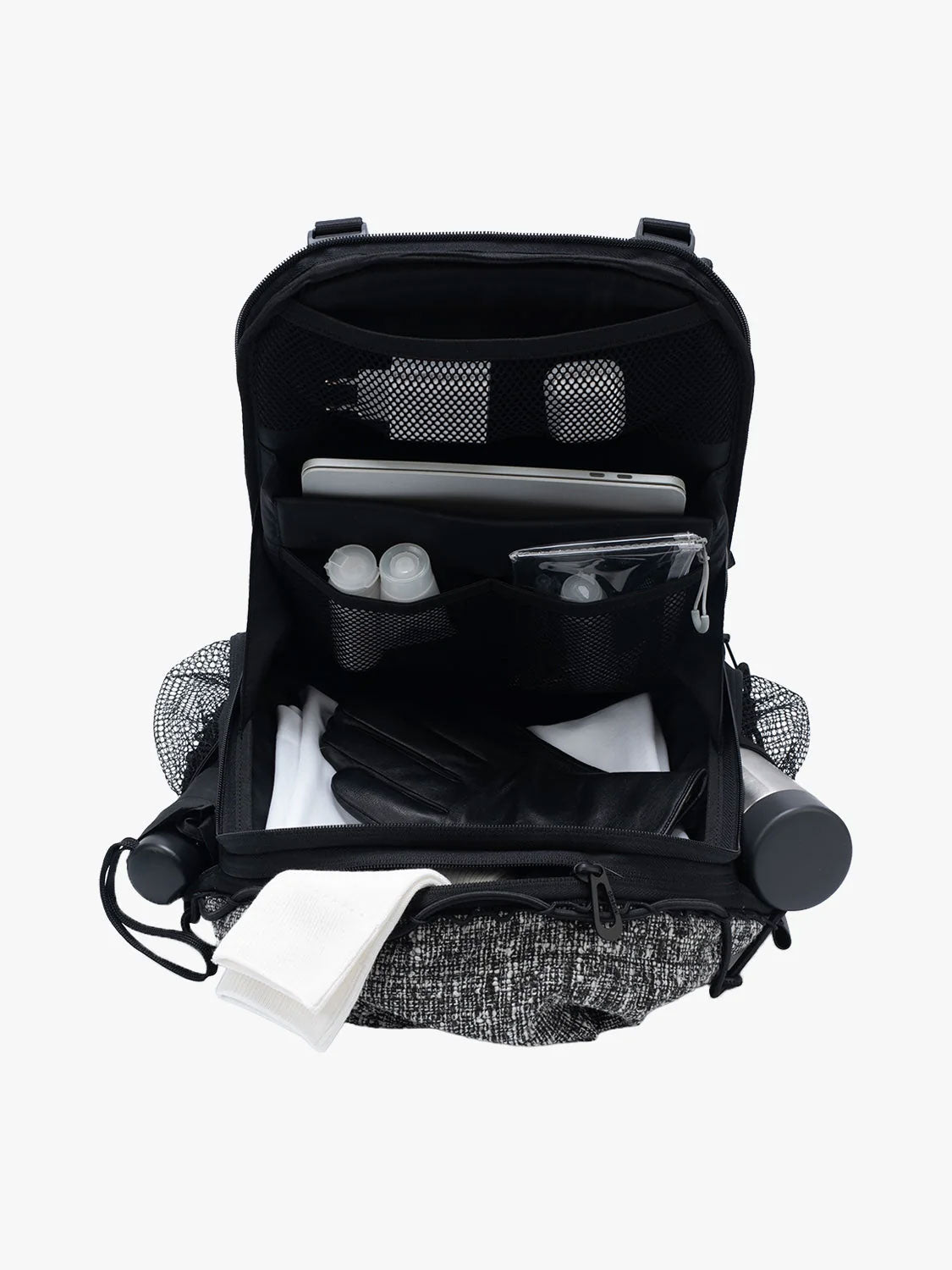Open Côte & Ciel Ladon Tweed in Black & Cream backpack showing laptop compartment, mesh pockets and organised interior