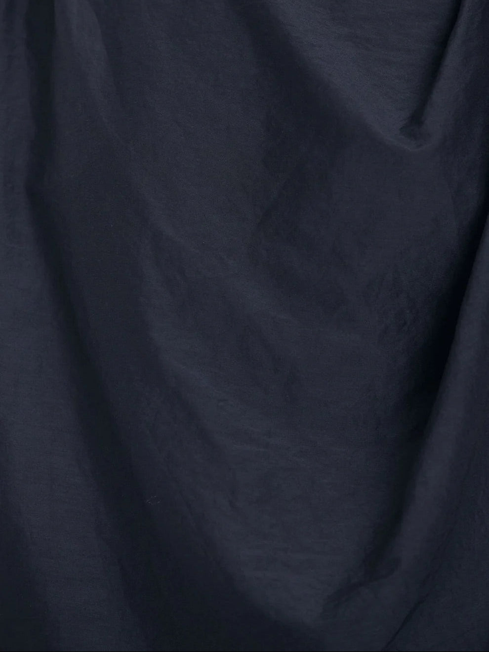 Black Crane Draped Dress in Faded Black - detail view showing silk cotton blend fabric texture