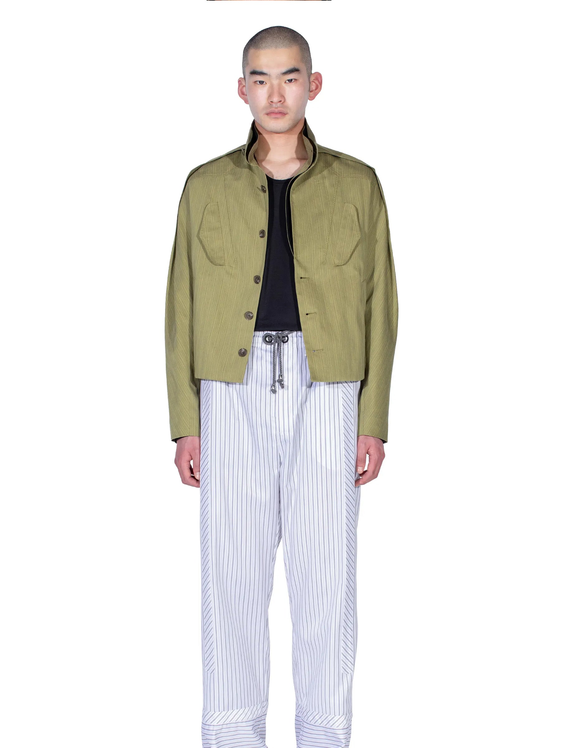Model wearing the Kiko Kostadinov Egreta Jacket in Lime Stripe from the front.
