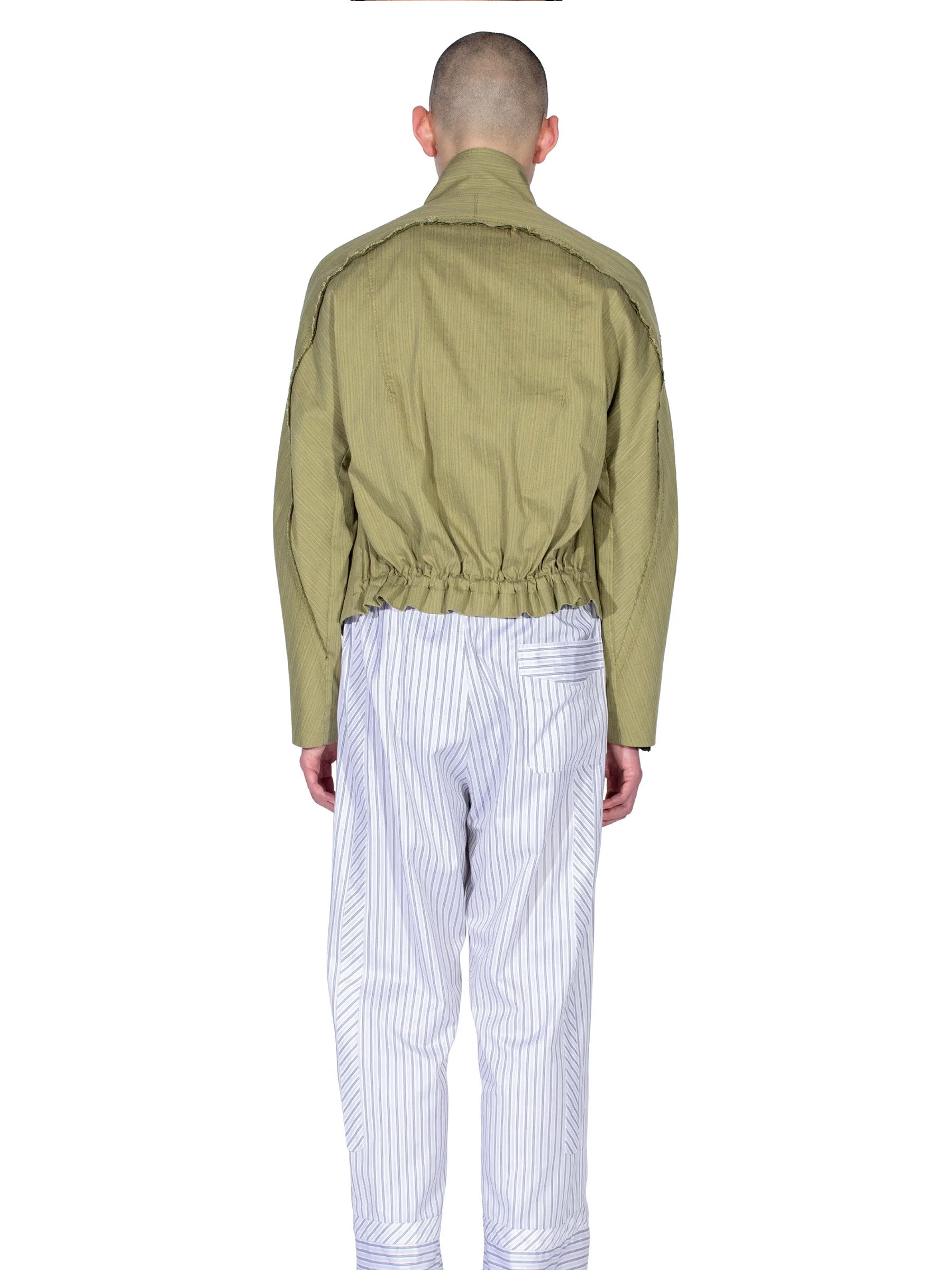 Rear view of the model wearing the Kiko Kostadinov Egreta Jacket in Lime Stripe.
