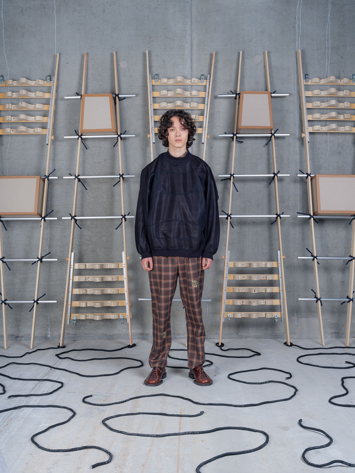 Henrik Vibskov Abstract Frog Top Black, model front view, styled with brown plaid trousers and brown leather shoes