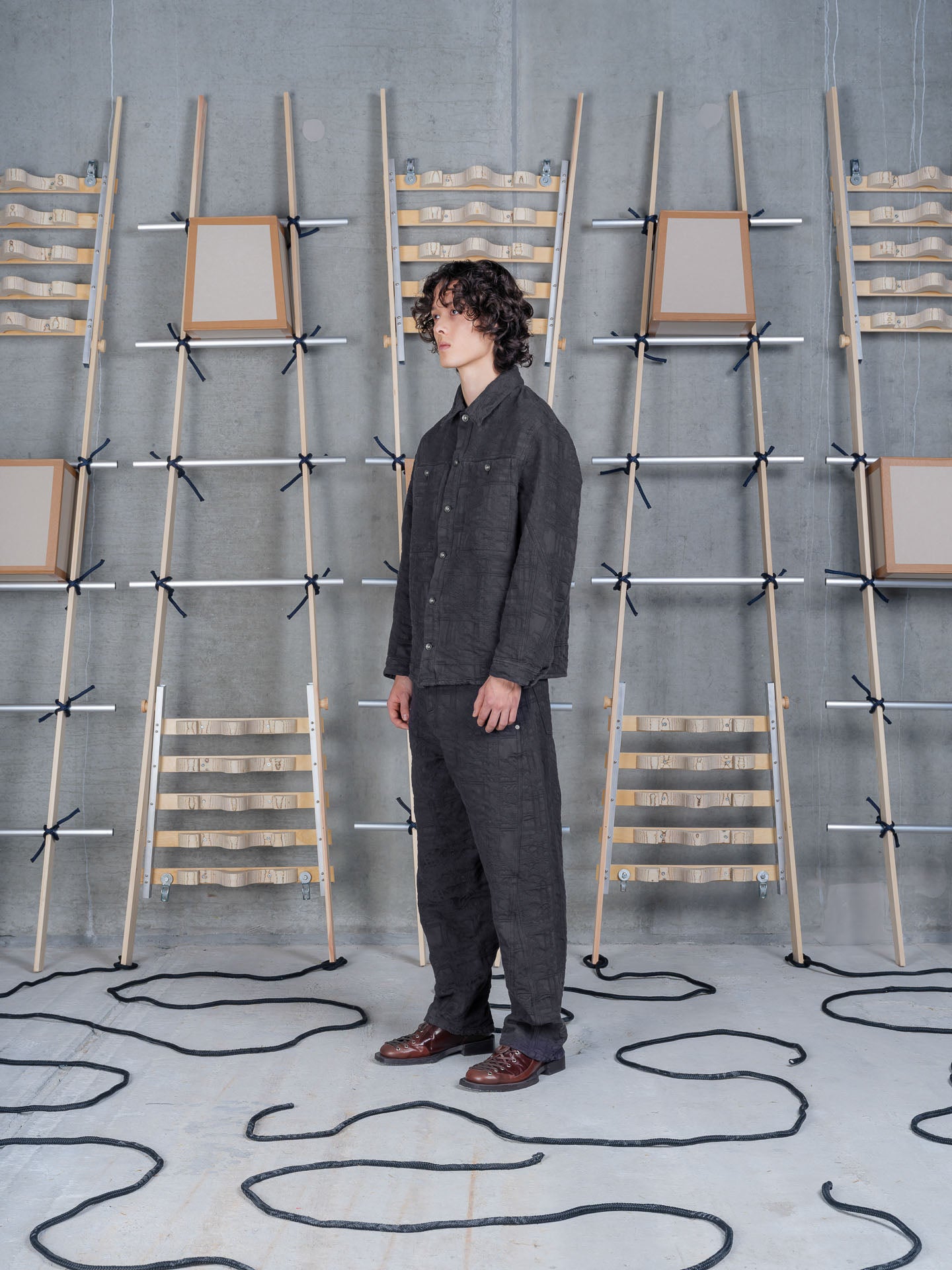Henrik Vibskov Amphi Pants Black, model side view, showing relaxed straight leg and cropped length
