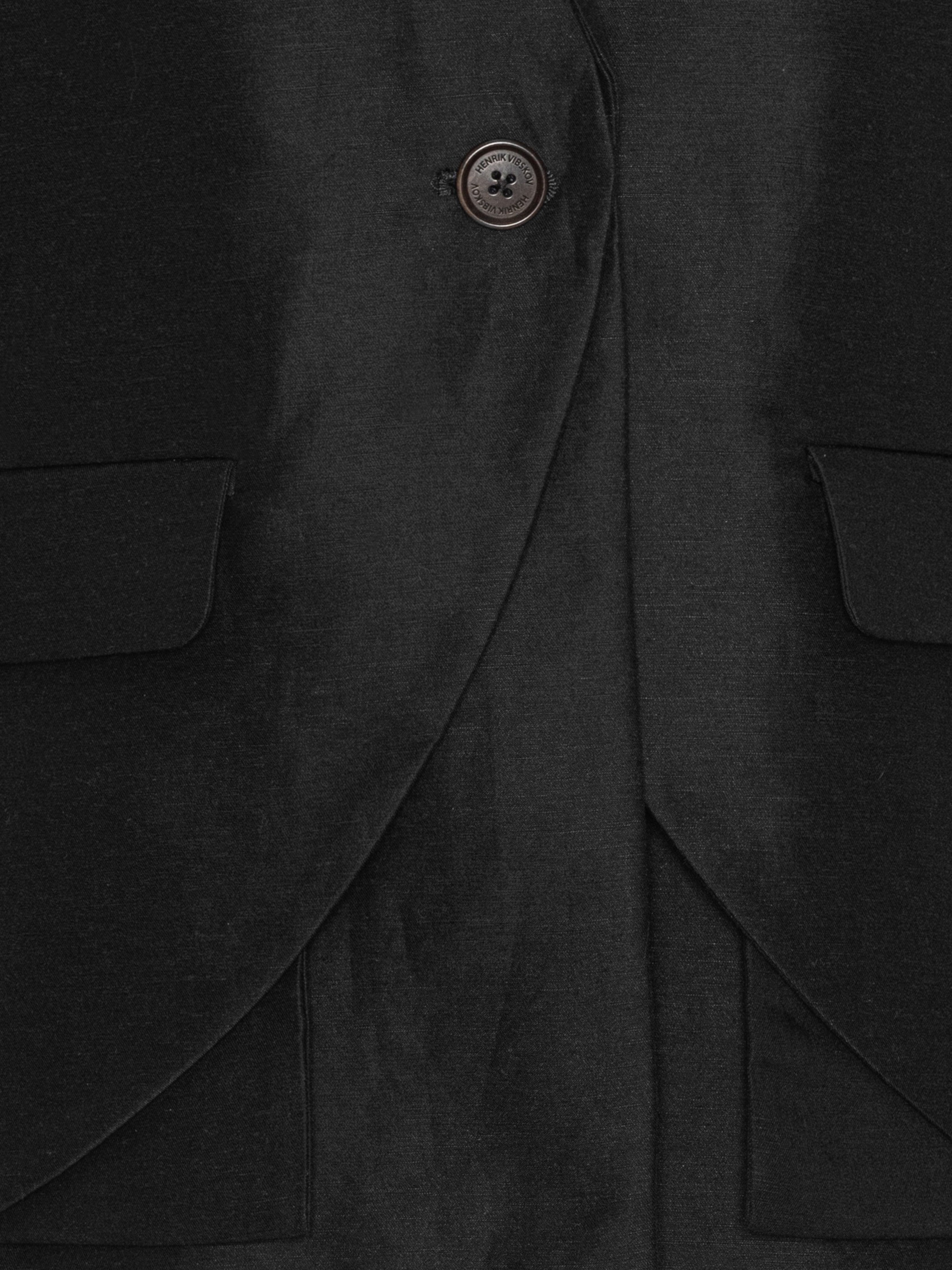Close-up of the Beetle Blazer highlighting the black Tencel-linen fabric and layered construction.
