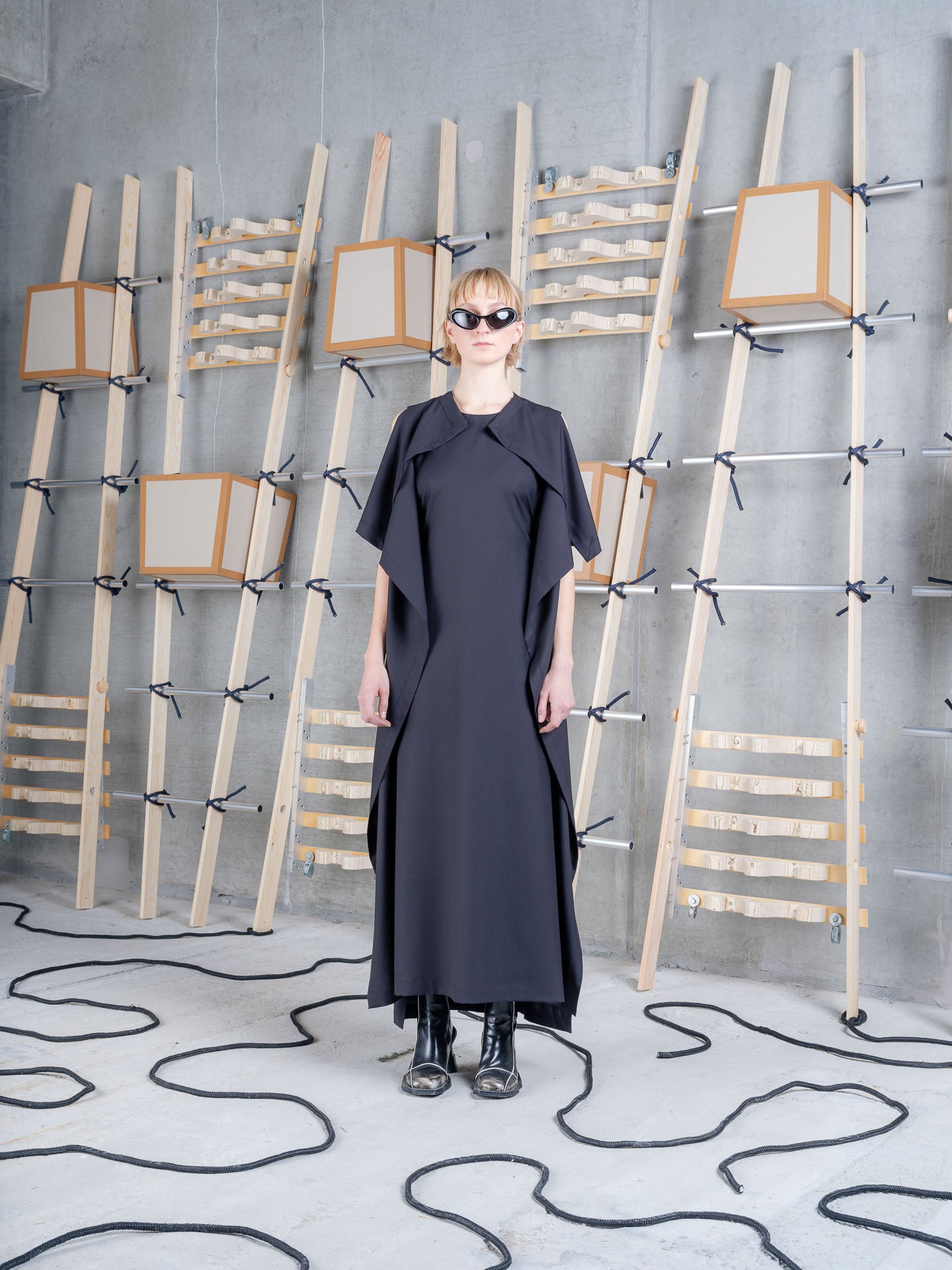 Model wearing the Henrik Vibskov Blanket Dress in black, front view