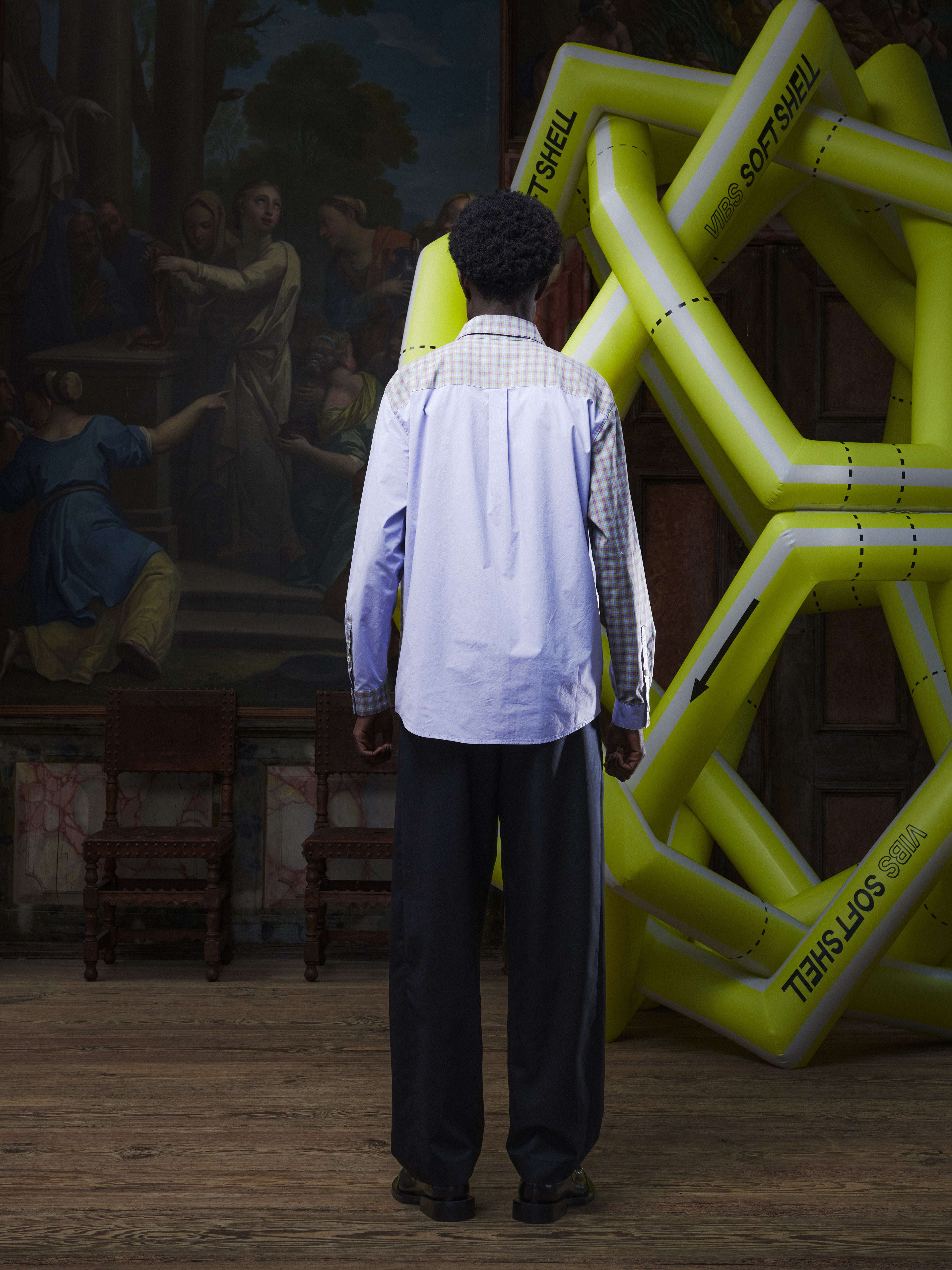 Back view of the male model wearing the Block Shirt in lilac from Henrik Vibskov Spring/Summer 2026 Studio Collection, highlighting the block design and curved hem.