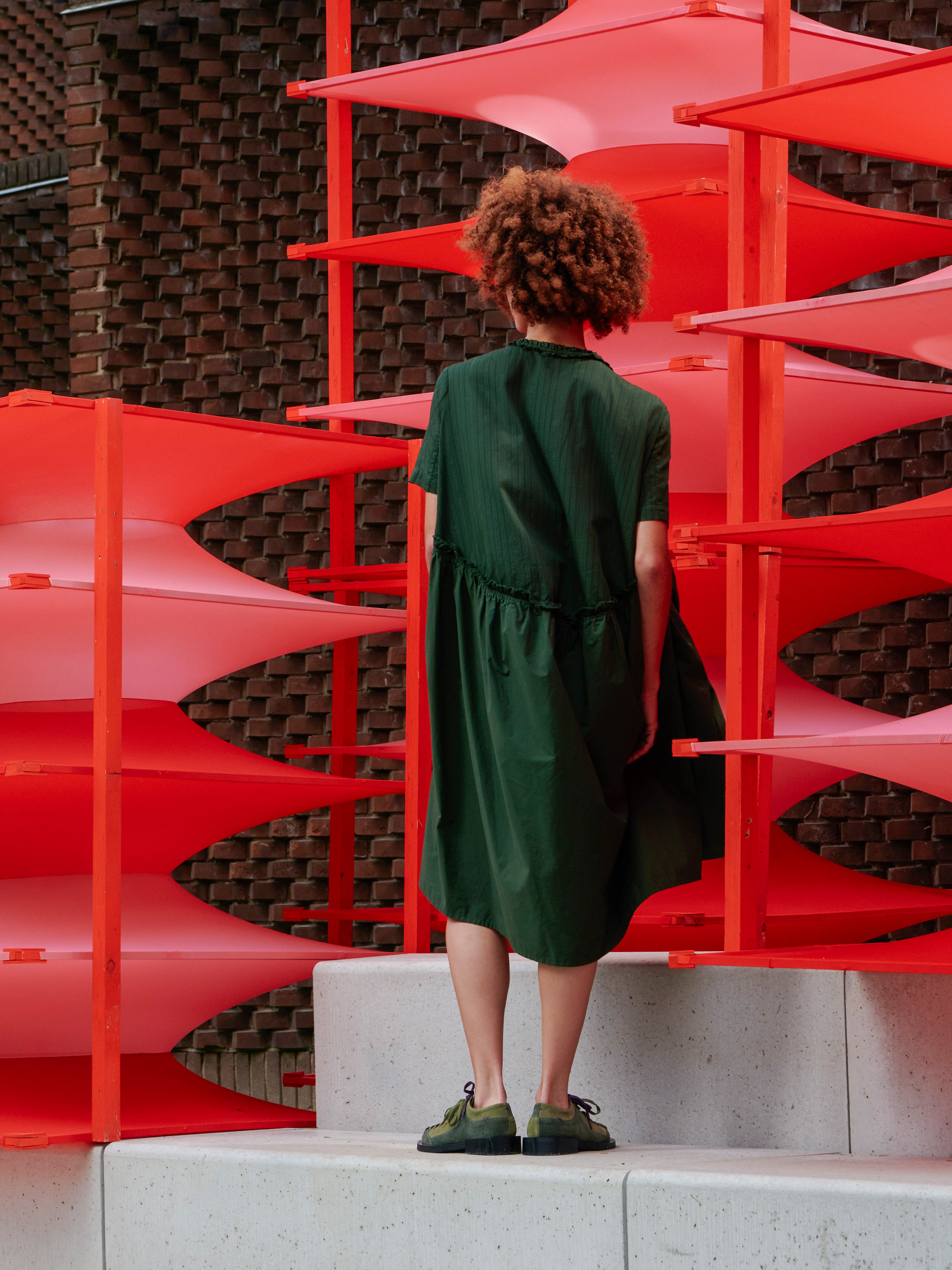 Back view of a model wearing the Bon Chalant Dress showing the oversized fit and ruched texture.