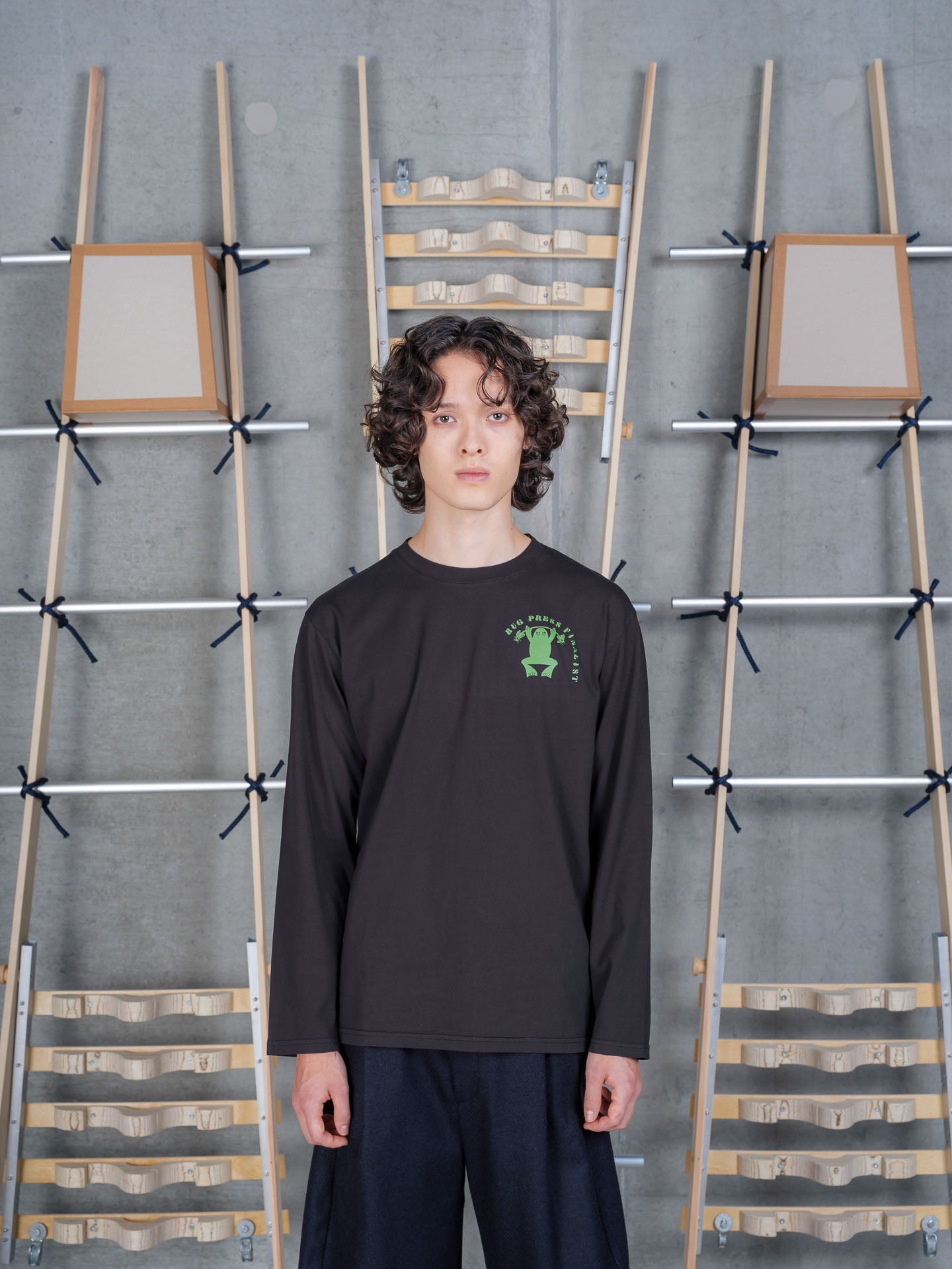 Henrik Vibskov Bug Press Blouse in Black worn on model, full-length front view, green frog graphic chest print, long-sleeve crew neck, relaxed fit