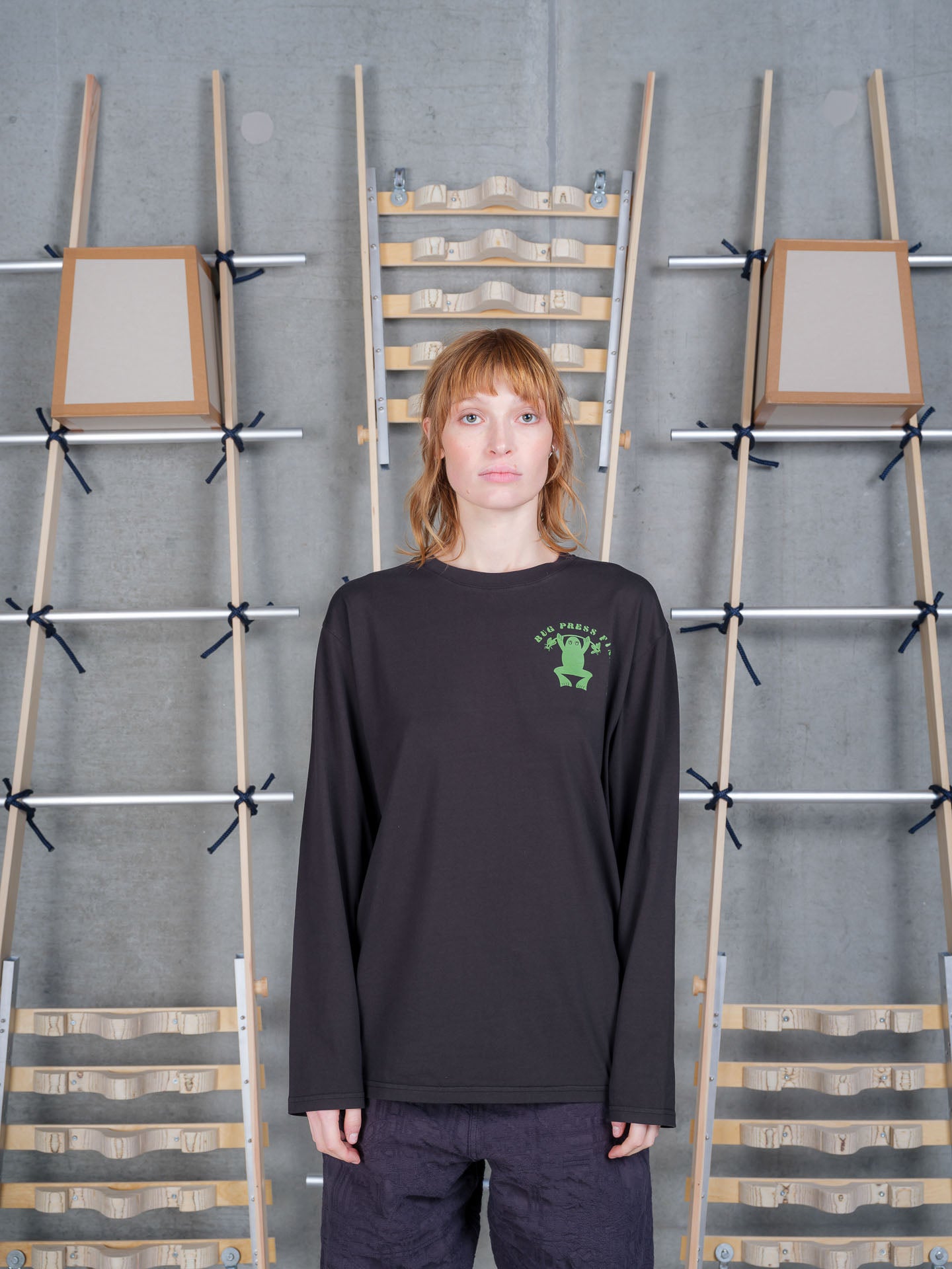 Henrik Vibskov Bug Press Blouse in Black worn on model, full-length front view, green frog graphic chest print, long-sleeve crew neck, relaxed fit