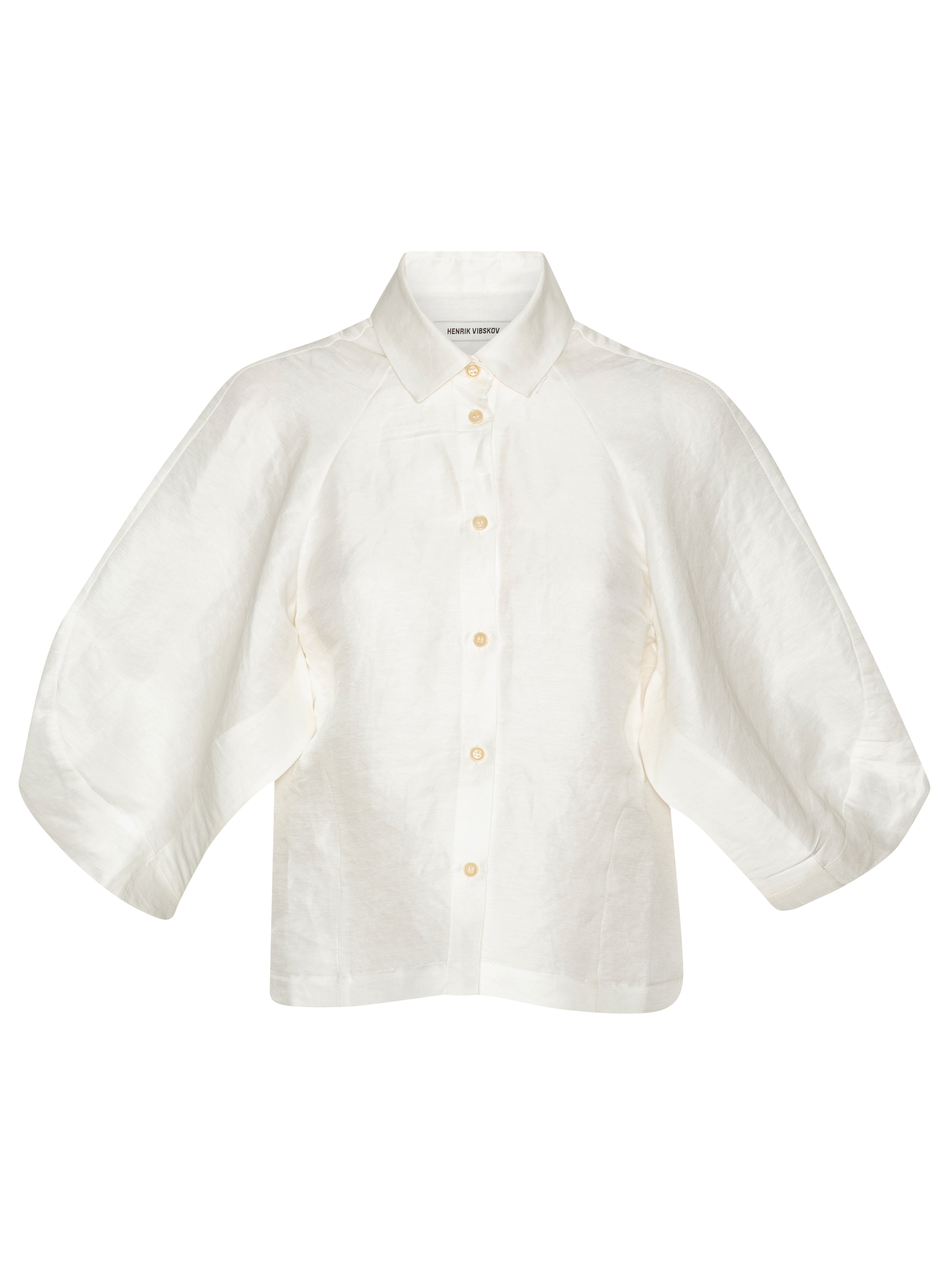 Front full-body packshot of the Case Shirt in White from Henrik Vibskov Spring/Summer 2026 Studio Collection, featuring 3/4-length raglan sleeves, a classic shirt collar, front button closure, and a straight hem.