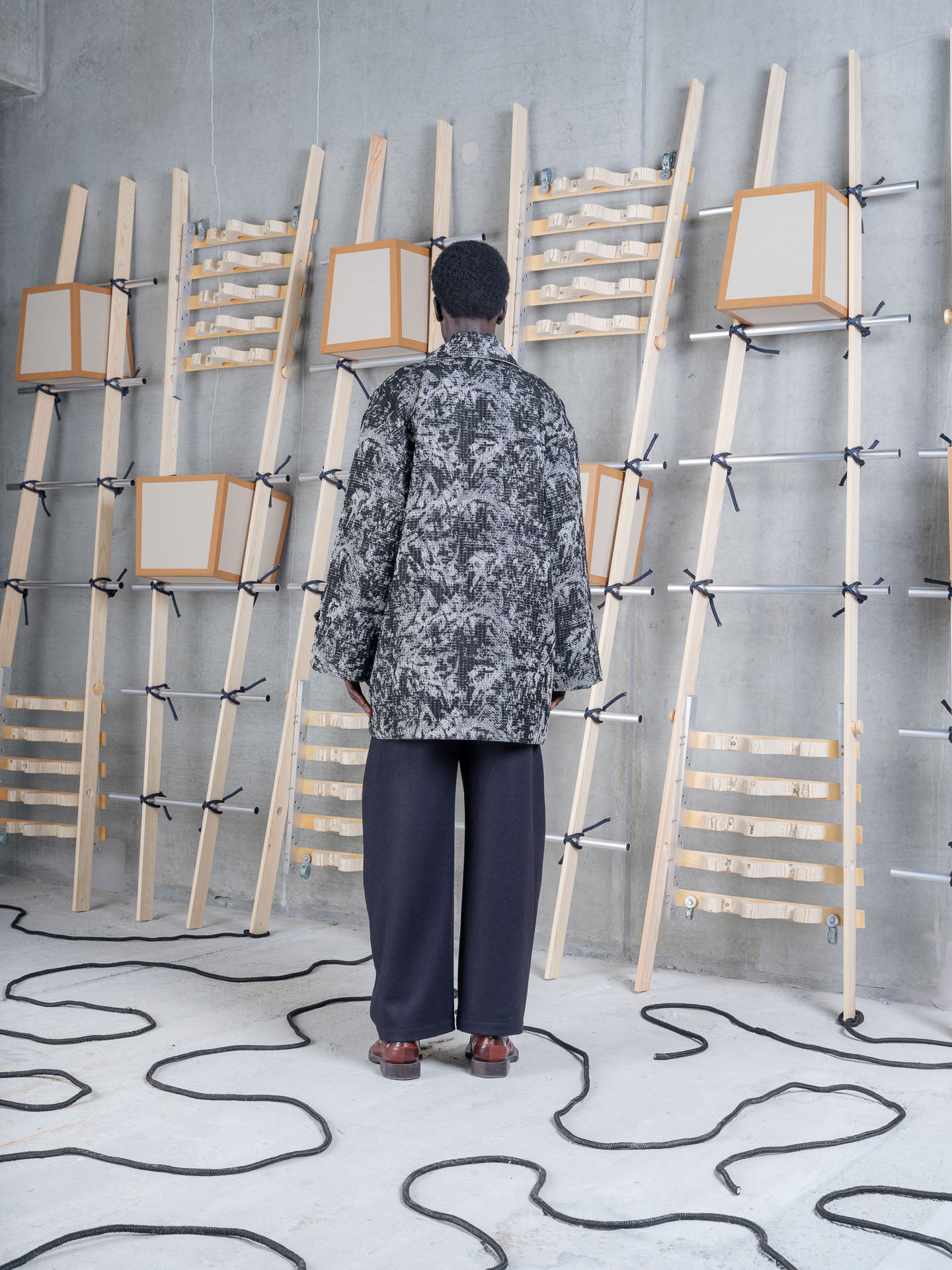 Henrik Vibskov Dimout Coat in Black 3D White on-model back view, textured jacquard tweed, oversized fit, turn-back cuffs