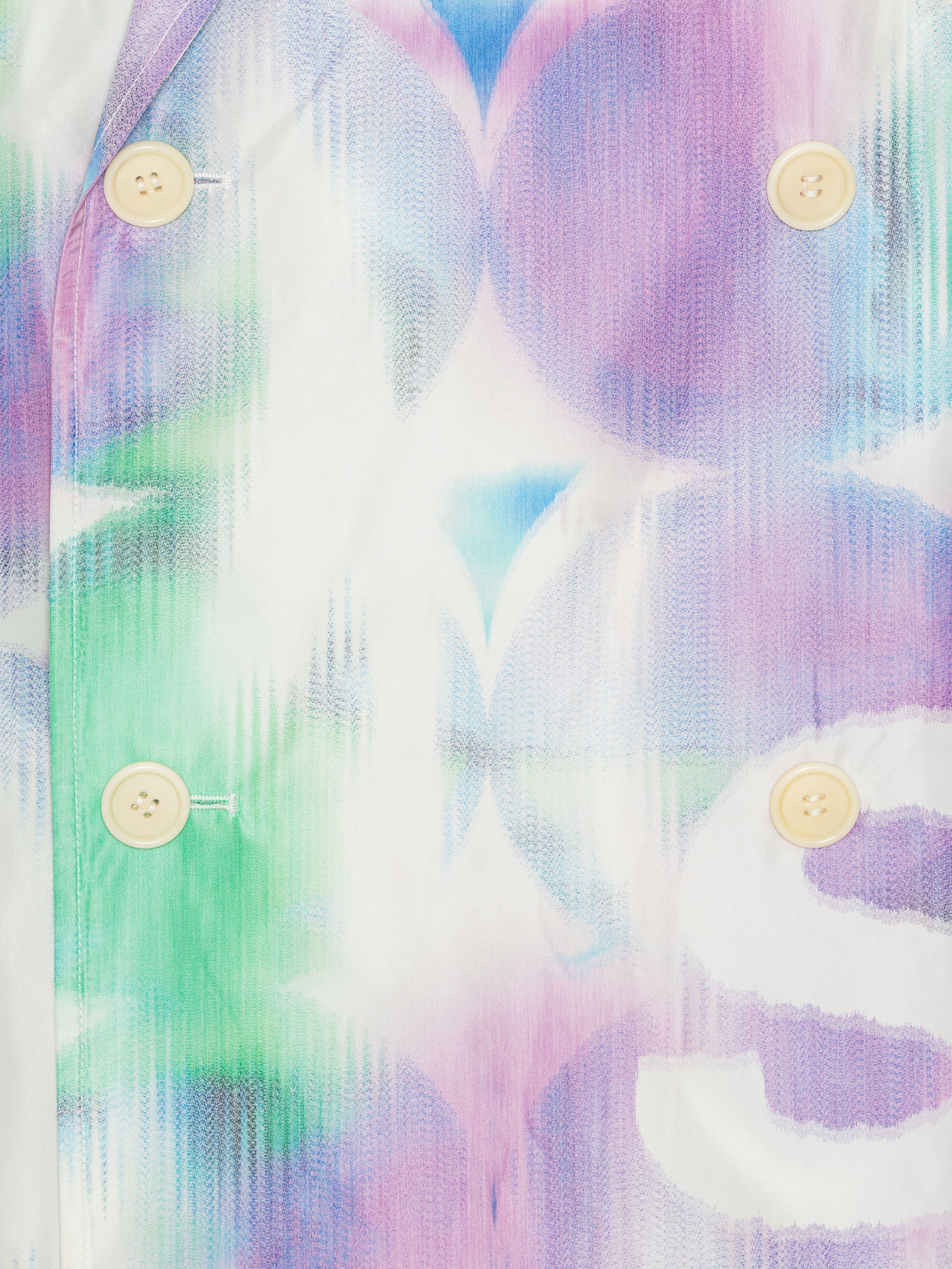 Close-up of the Dimout Long Coat in Bubble Wrap, highlighting the detailed multicolour abstract print and double-breasted button closure.