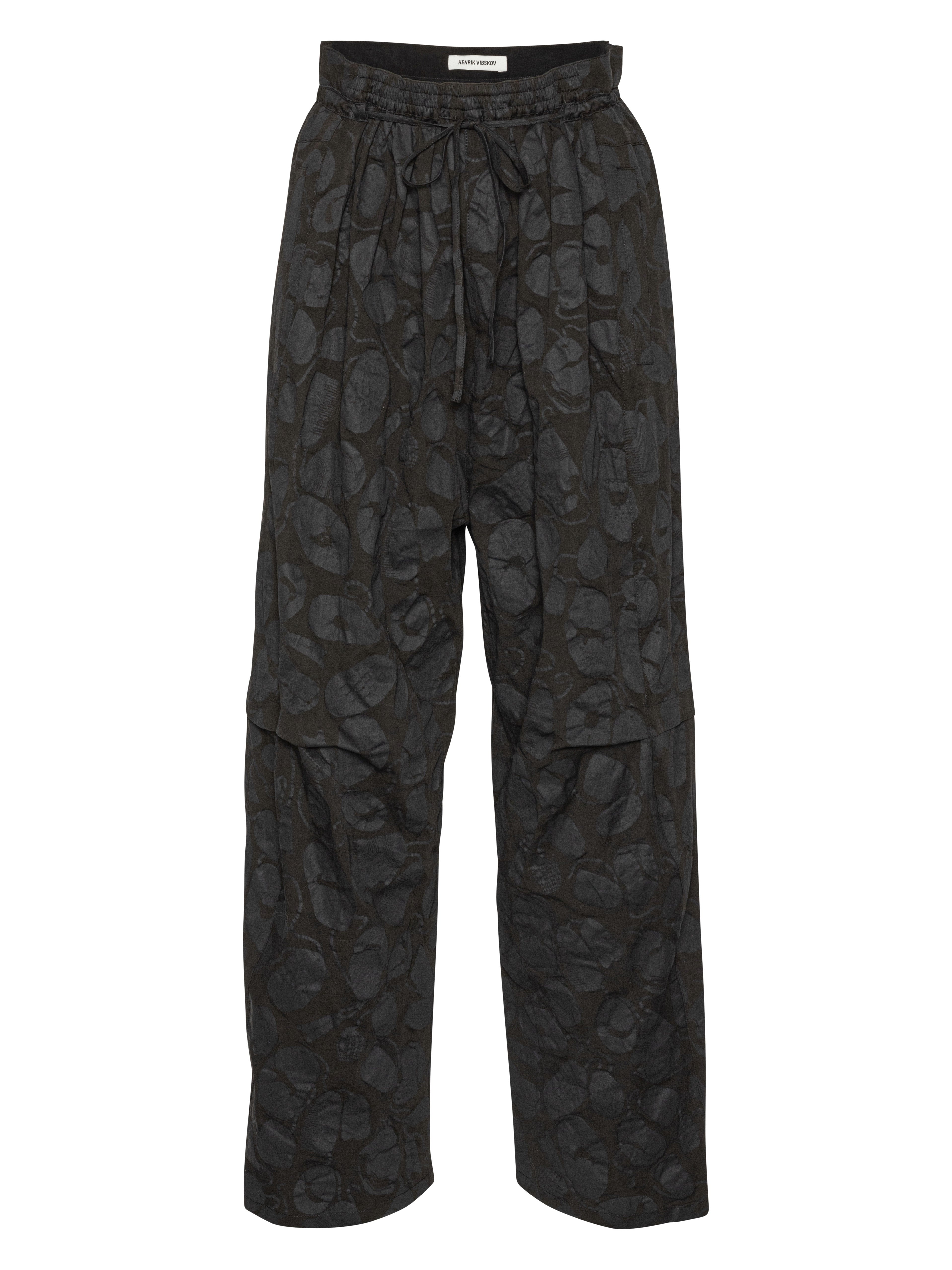Front view of the Drawstring Pants in Black Amulets, showing the black fabric with subtle amulets pattern, straight legs, and elastic drawstring waistband.