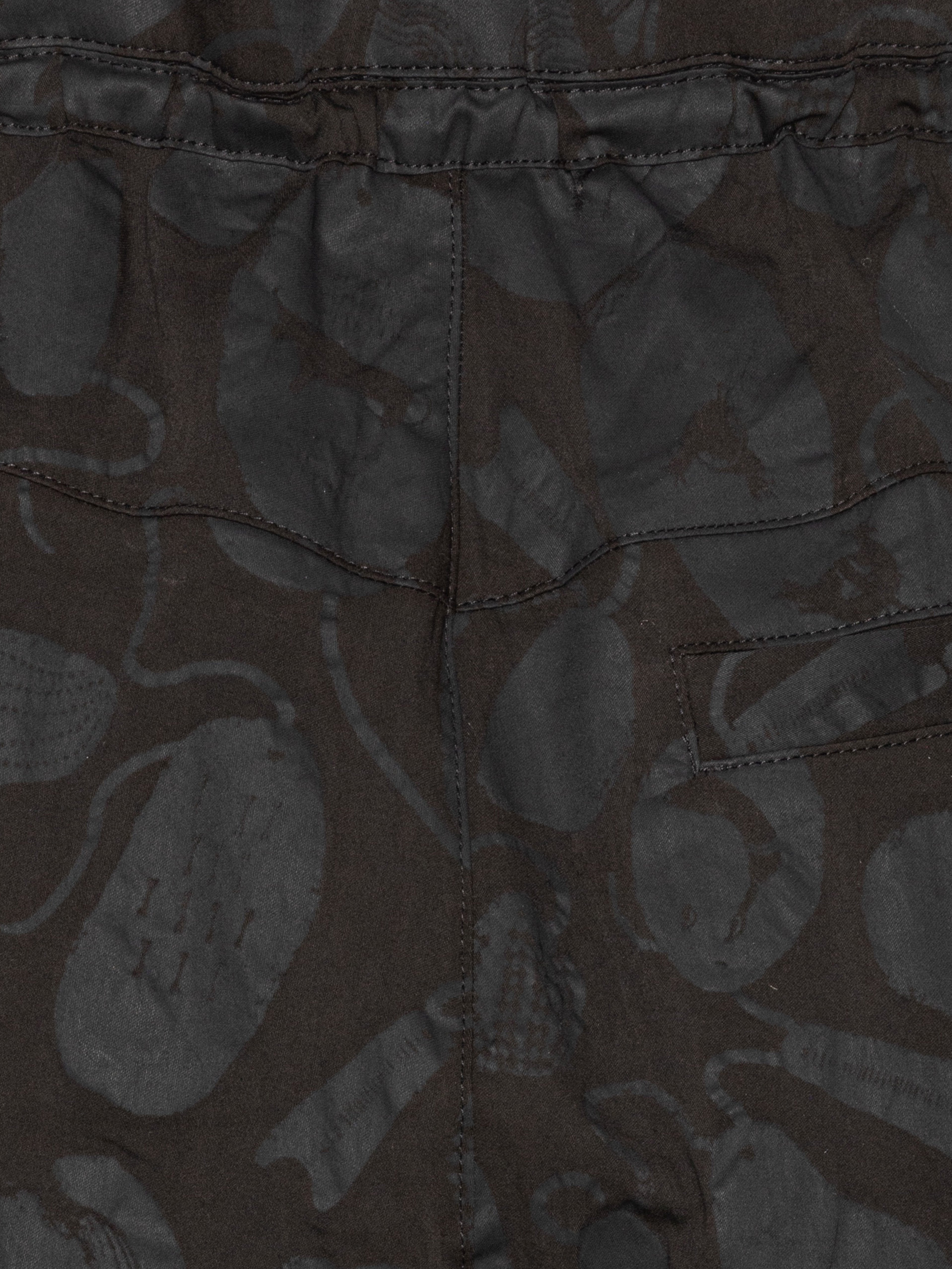 Close-up of the Drawstring Pants in Black Amulets, highlighting the textured black amulets pattern and the elastic waistband with drawstring.