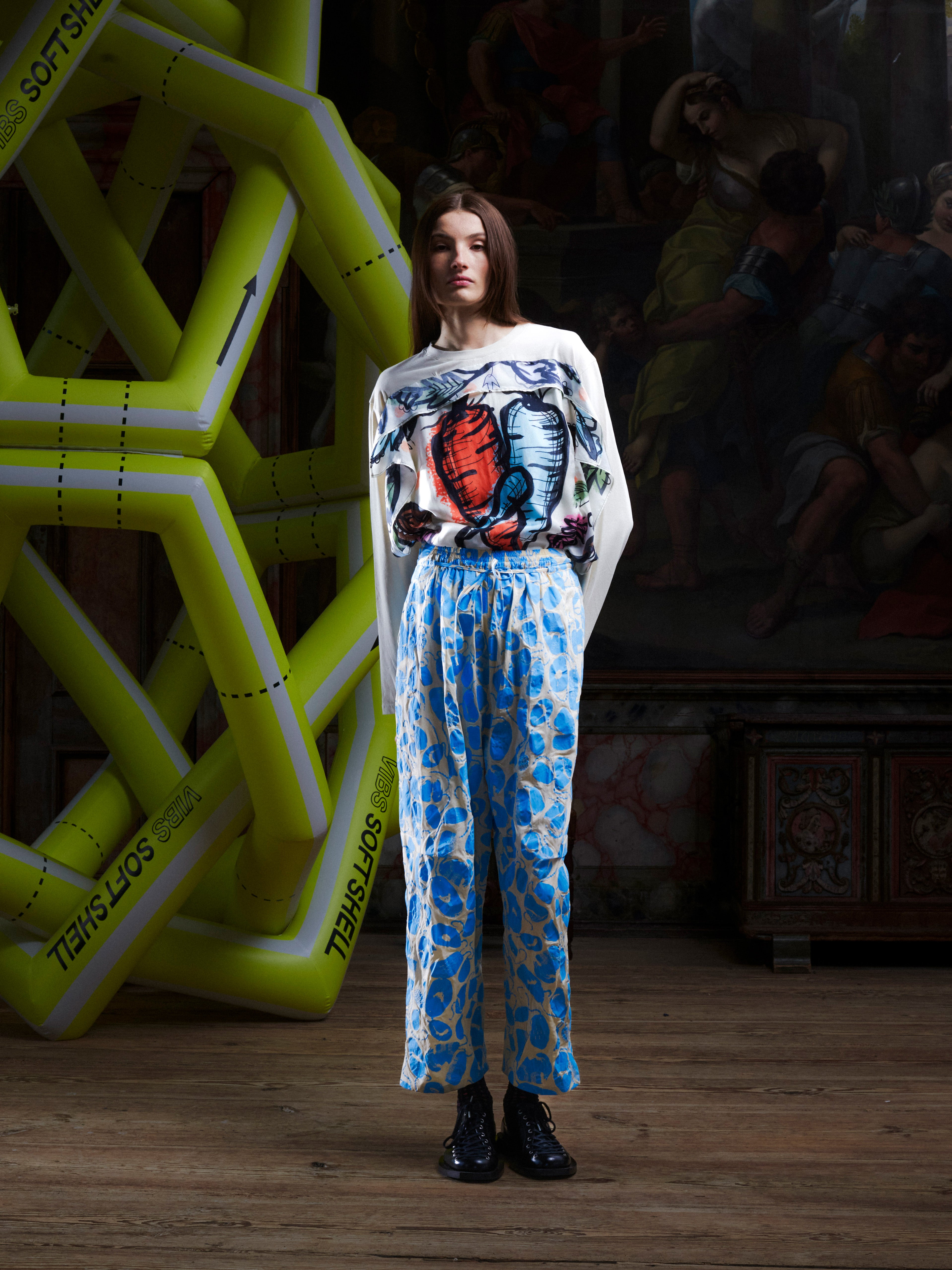 Female model wearing the Drawstring Pants in Ecru Amulets, front view. Model is 185 cm and wears size S, showing the relaxed straight fit, side pockets, and elastic drawstring waistband.