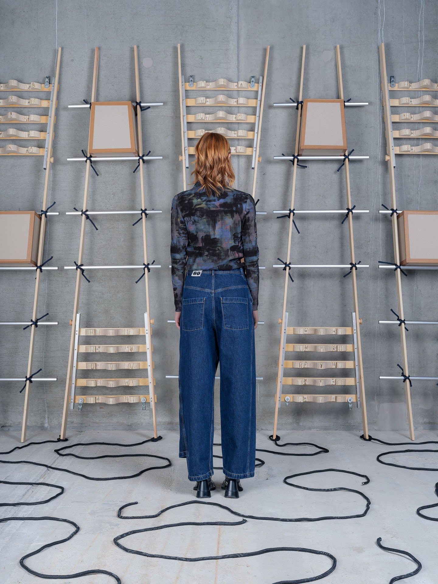 Henrik Vibskov Fly Pants Rinse Denim, model rear view, showing back pockets and silhouette