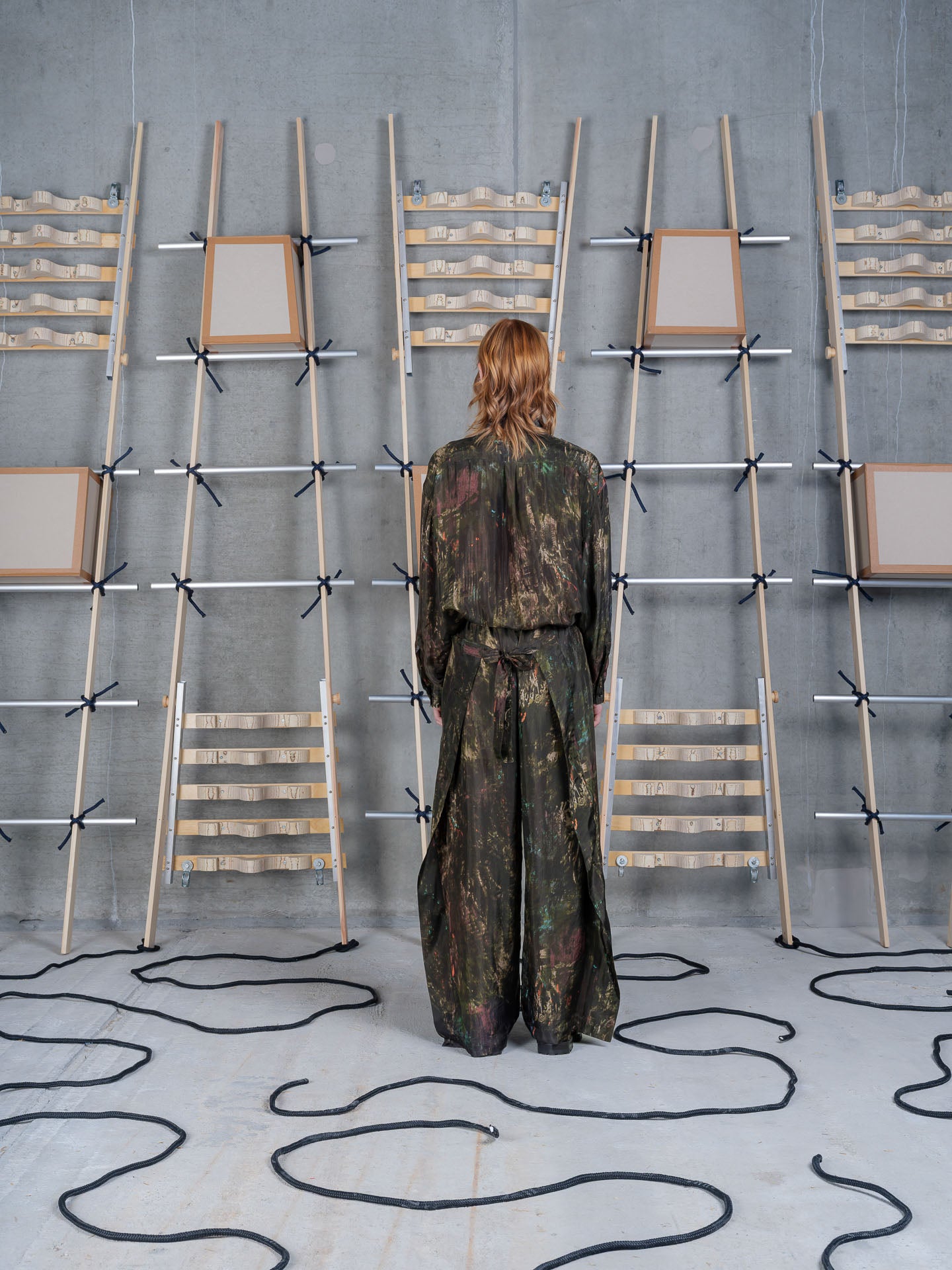 Henrik Vibskov Fold Pants Swamp Reflections, model rear view, showing back silhouette and tie waist detail
