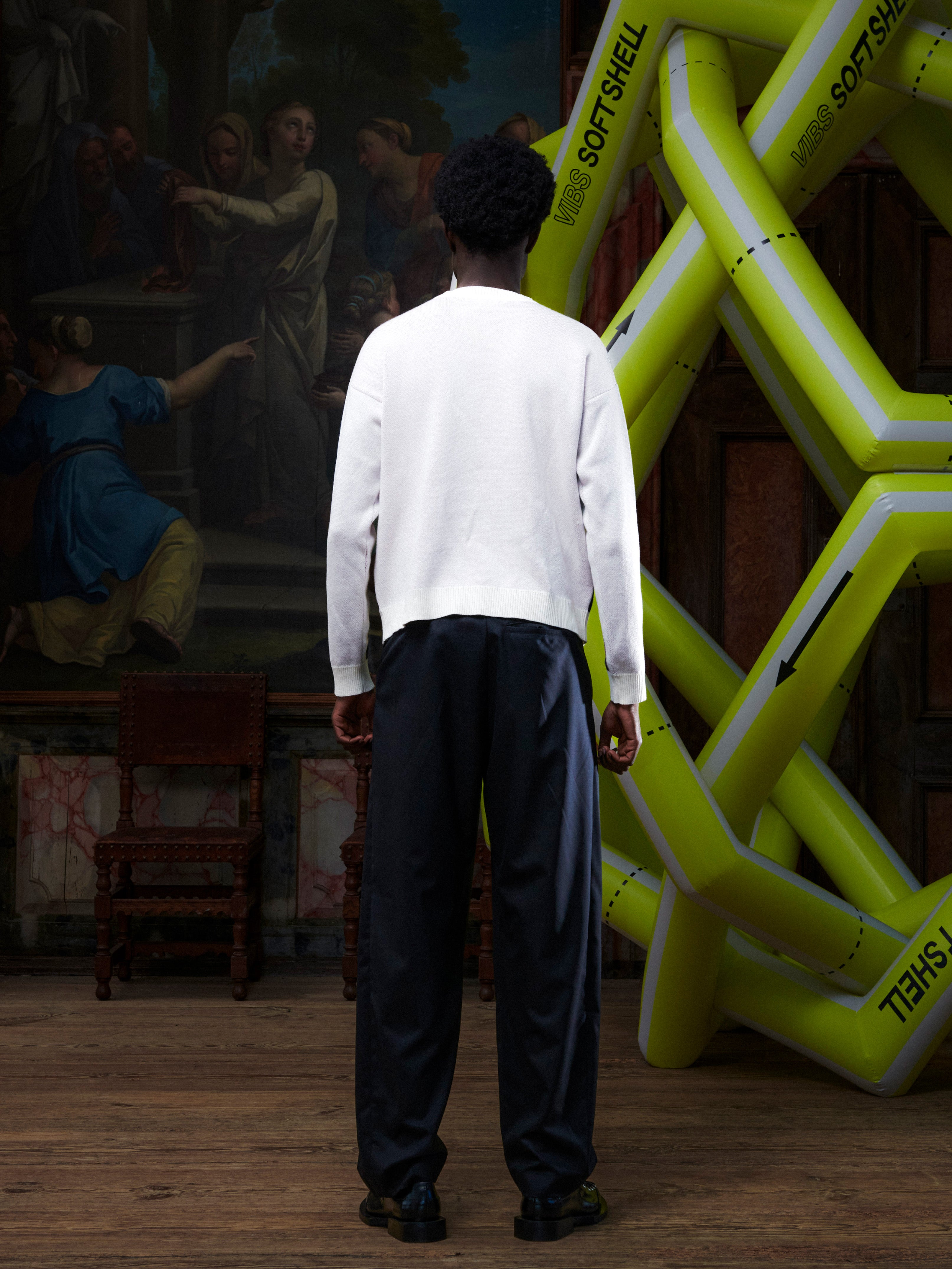 Male model wearing the Henrik Vibskov Frigate Crewneck in Frigate, back view, showing the clean off-white back and ribbed hem and cuffs.