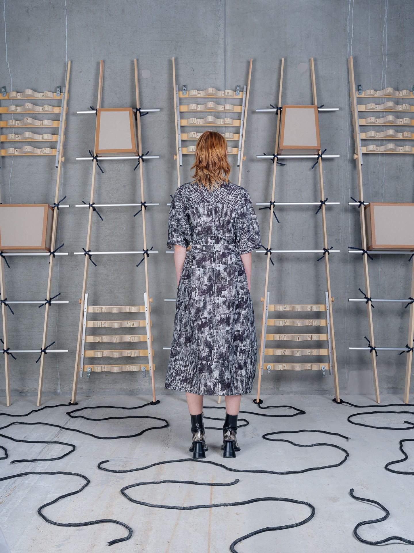Model wearing the Henrik Vibskov Frown Silk Dress in Jumping Gents print, back view