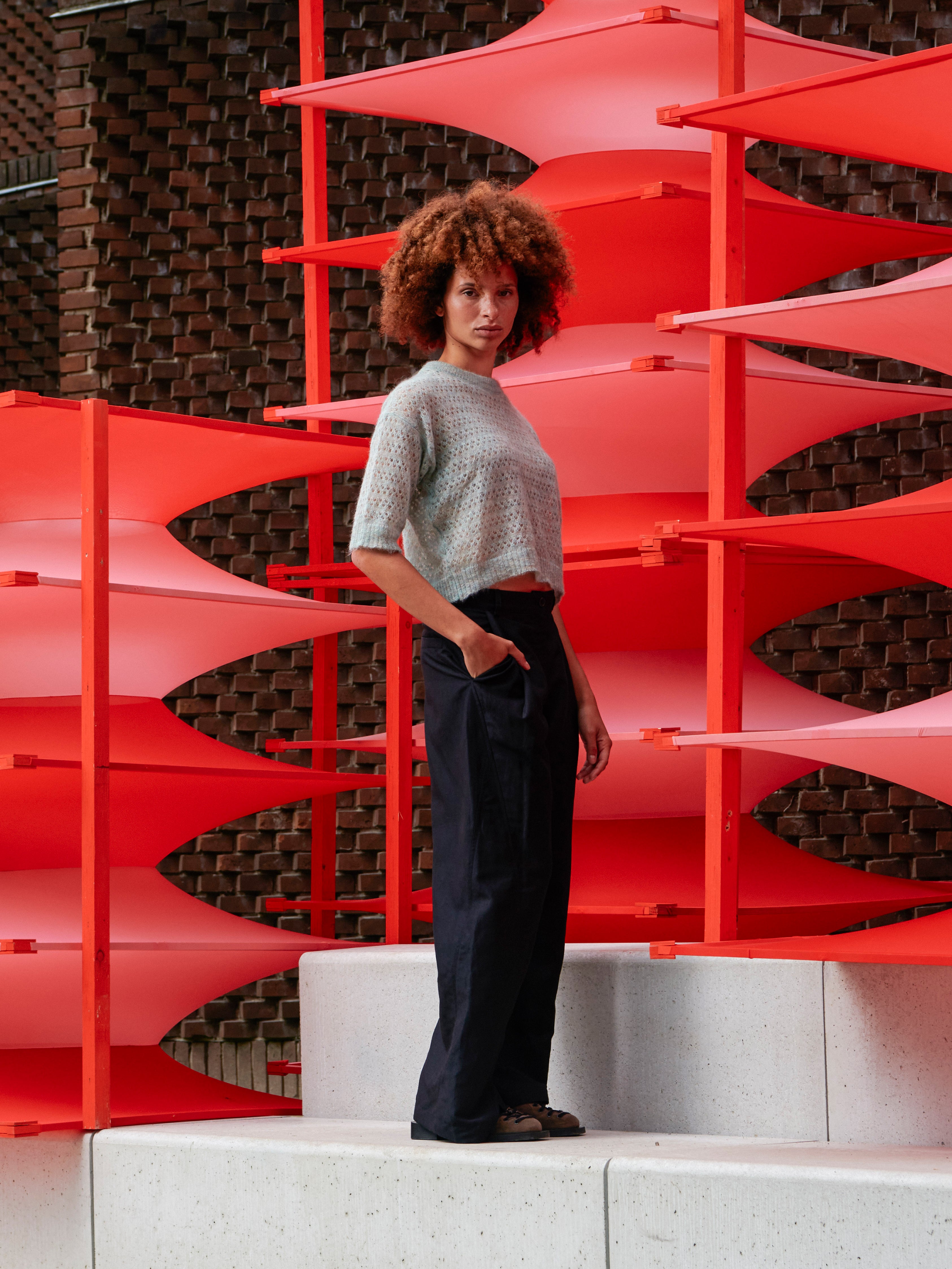 Model wearing the Hug Knit Tee in Multi Hug mint cropped knit tee with relaxed silhouette and elbow length sleeves, side view – Henrik Vibskov Spring/Summer 2026 Key Collection