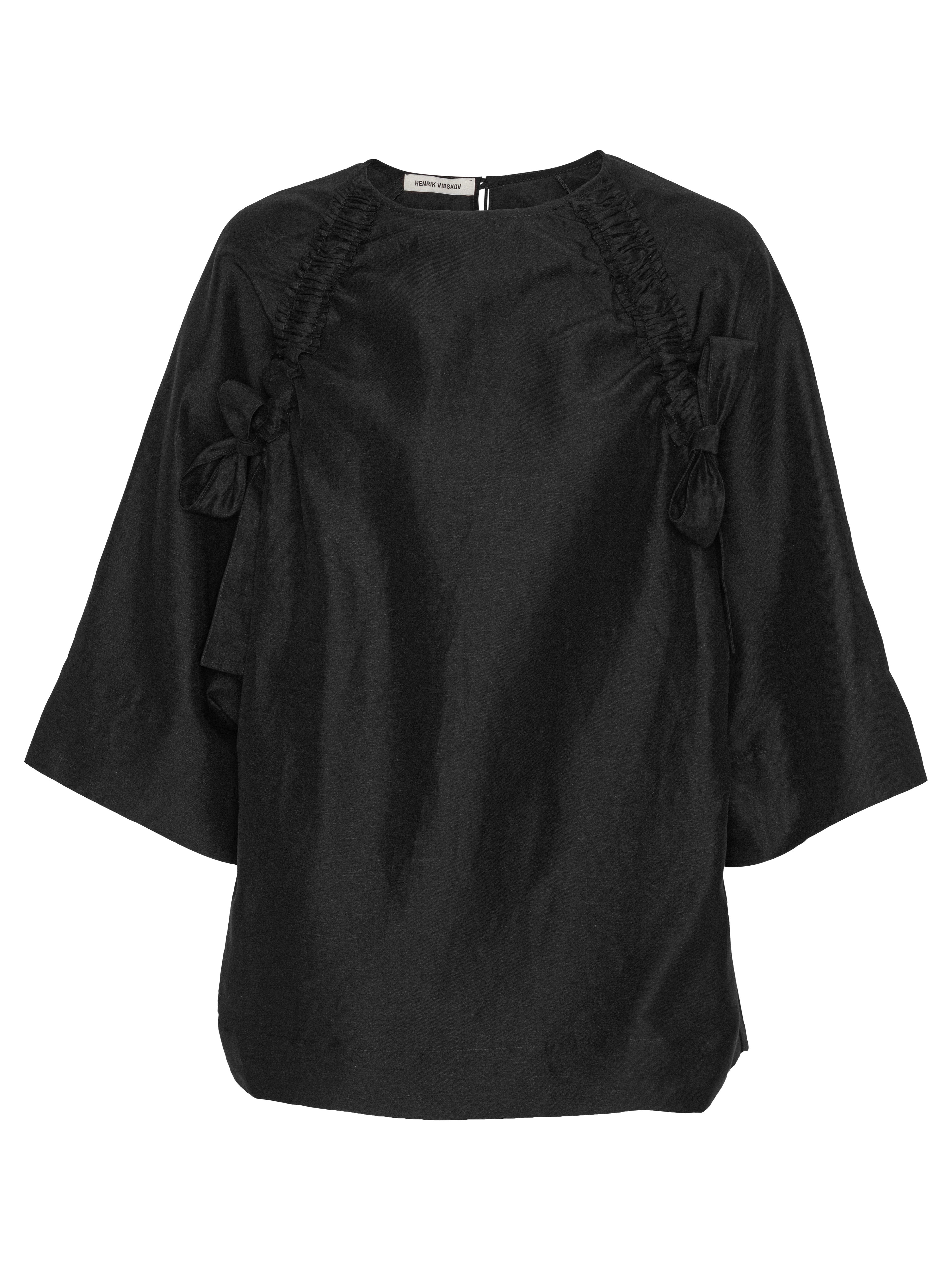Front view of the Insurance Top in black Tencel-linen blend with round neck, oversized silhouette, and straight hem.