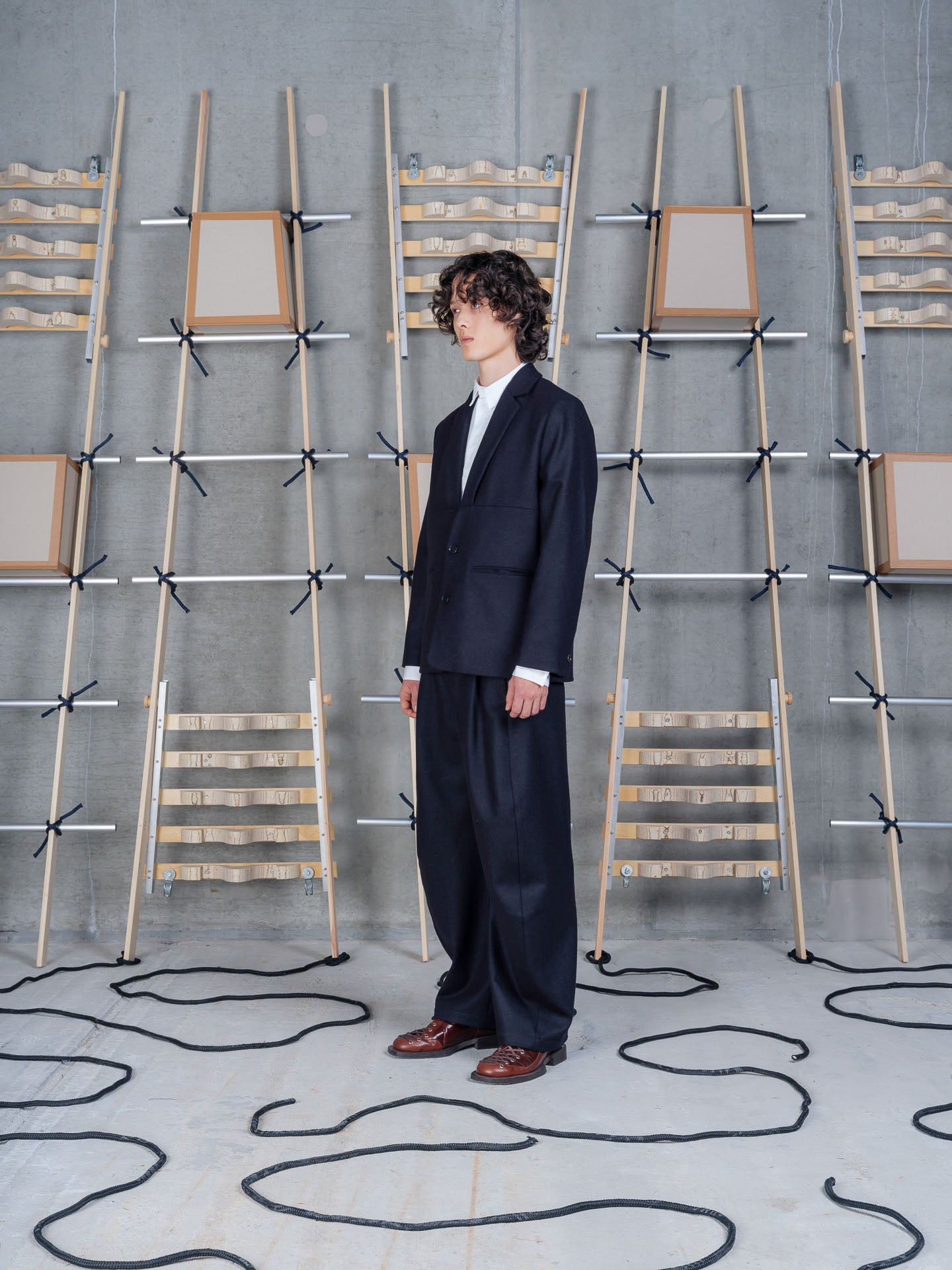 Henrik Vibskov Lonely Blazer in Black on-model side profile view, relaxed fit, dropped shoulder seam, flap and welt pocket detail