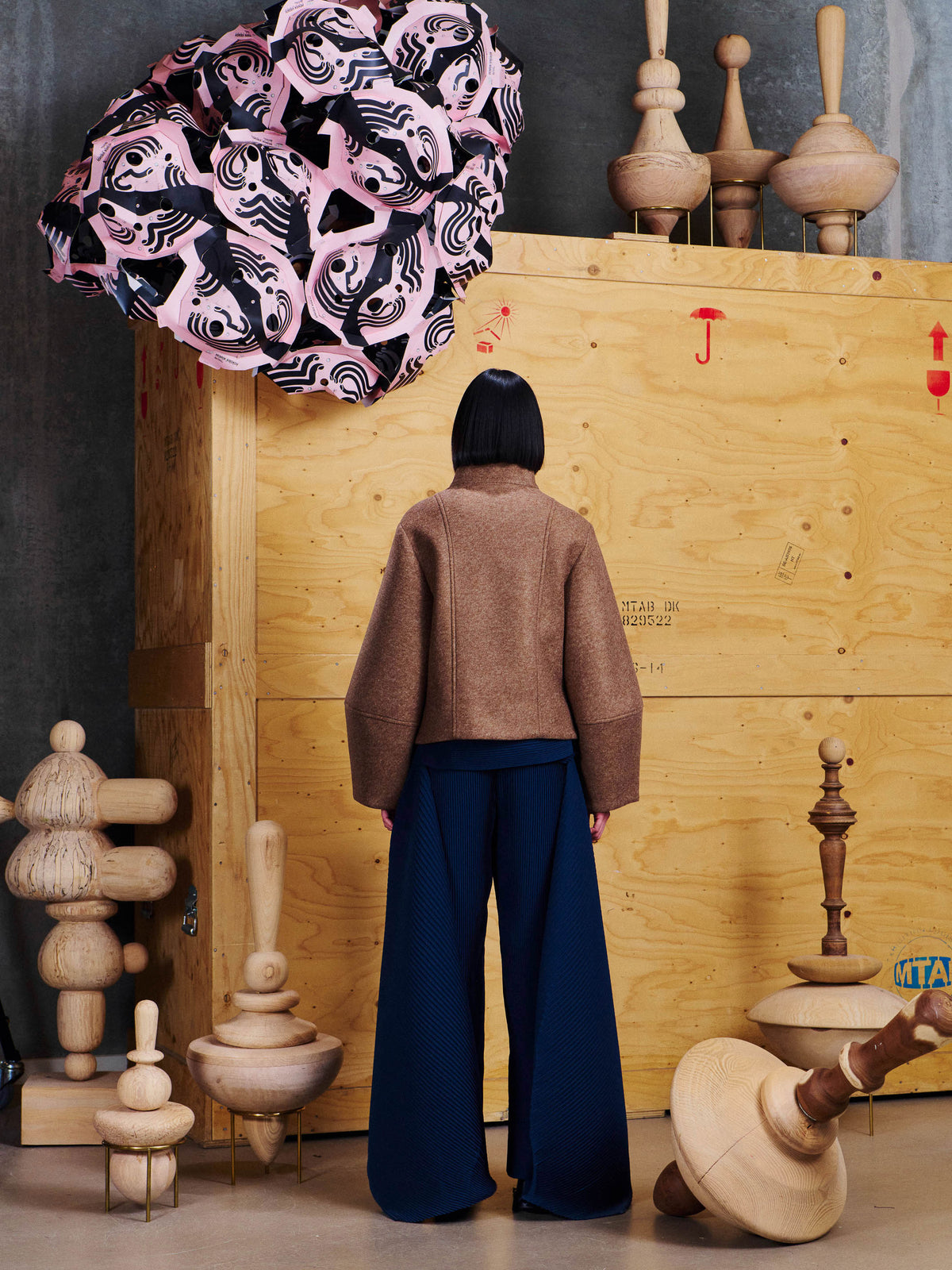 Back view of model wearing the Henrik Vibskov Moon Short Jacket in Camel, showing the clean cropped back and sculptural sleeve shape.