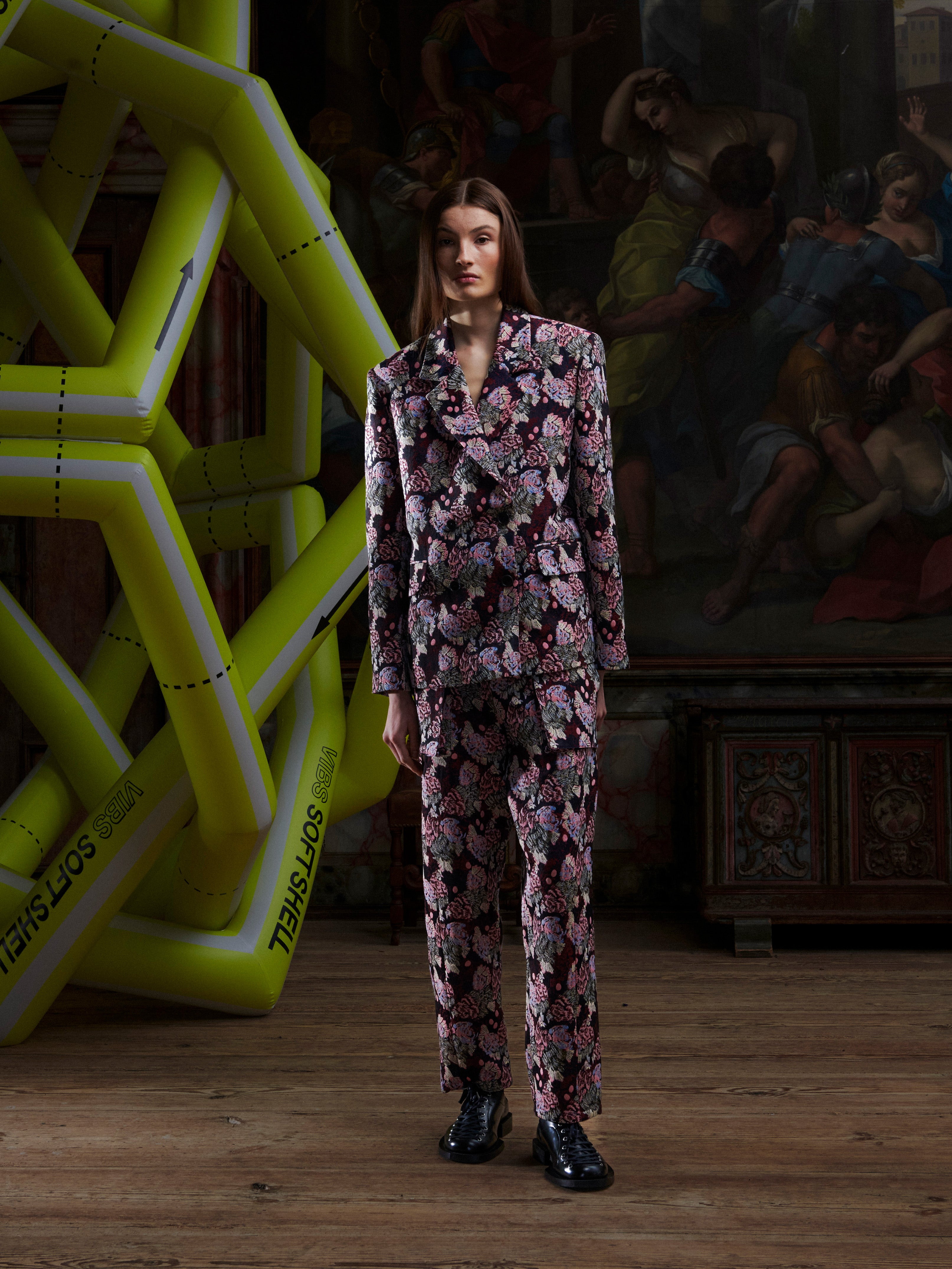 Female model wearing the Henrik Vibskov Motif Blazer in Navy Chickens, front view. The model is 185 cm and wears size L, showing the embroidered double-breasted blazer with flap pockets and square silhouette.