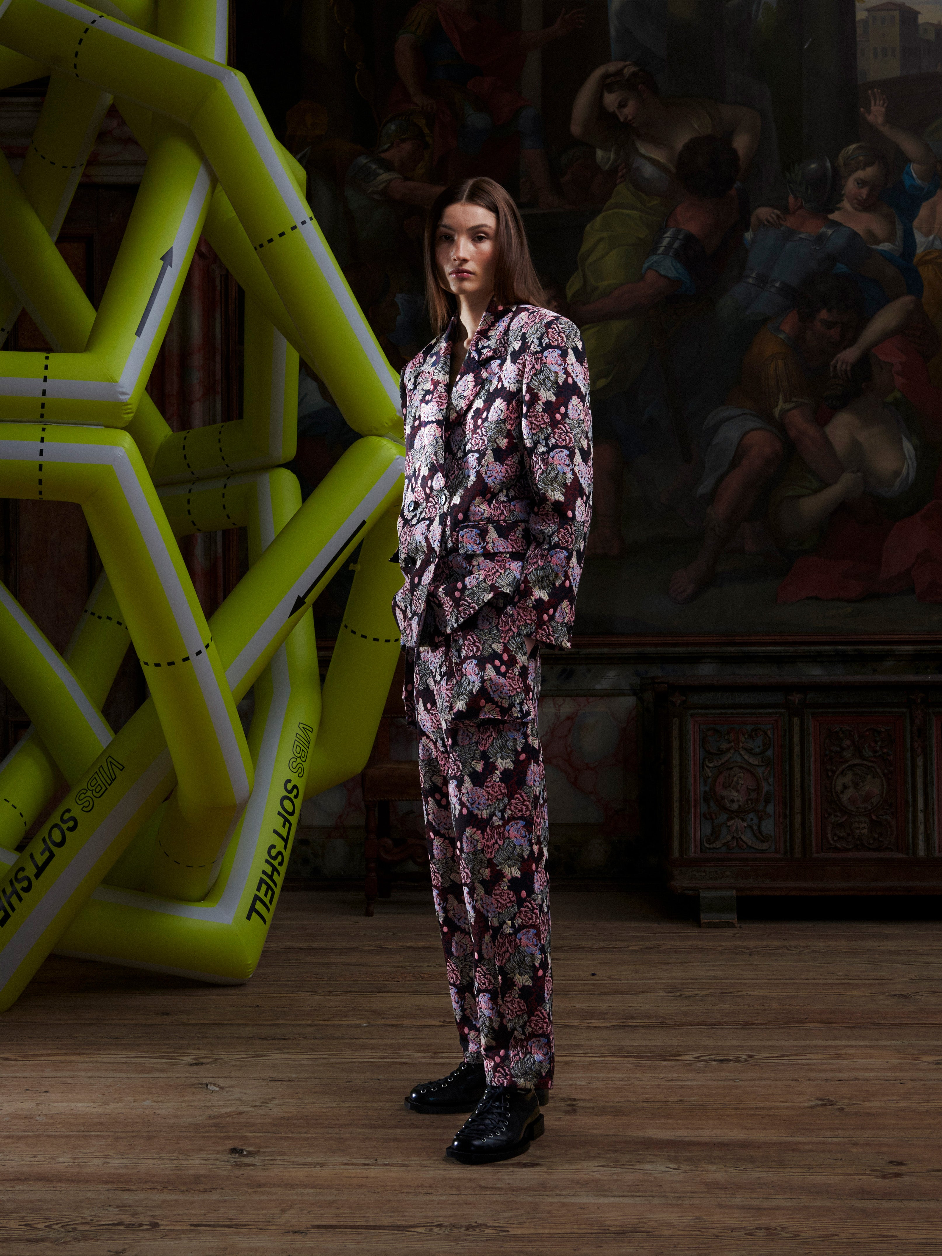 Female model wearing the Henrik Vibskov Motif Blazer in Navy Chickens, side view, showing the square fit, long sleeves, and embroidered detailing.