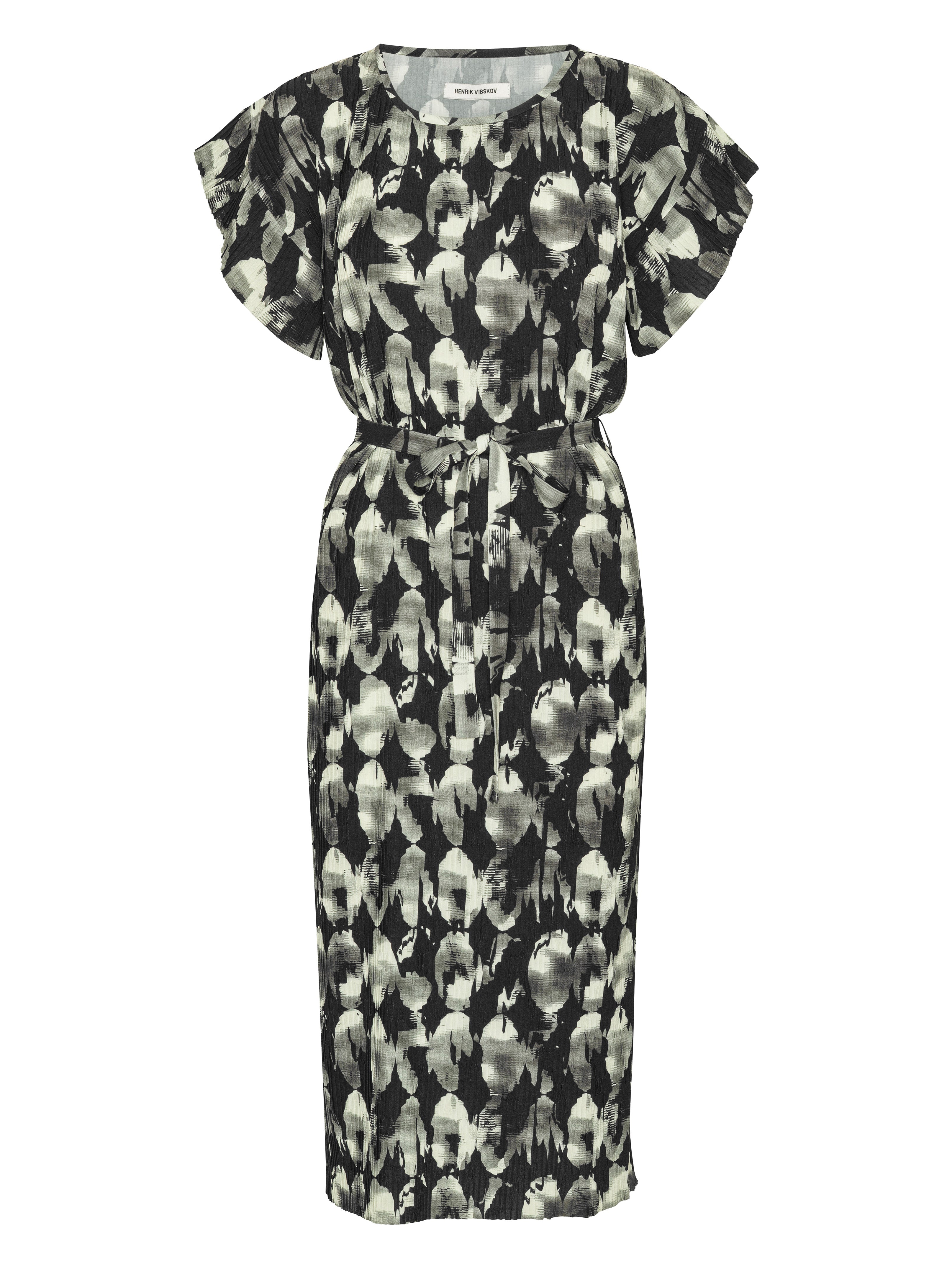 Front view of the Henrik Vibskov New Pina Plissé Dress in Bursting Eggs, showing the black, grey, and white abstract egg illustration, round neck, short sleeves, waist tie, full plissé texture, and straight hem.