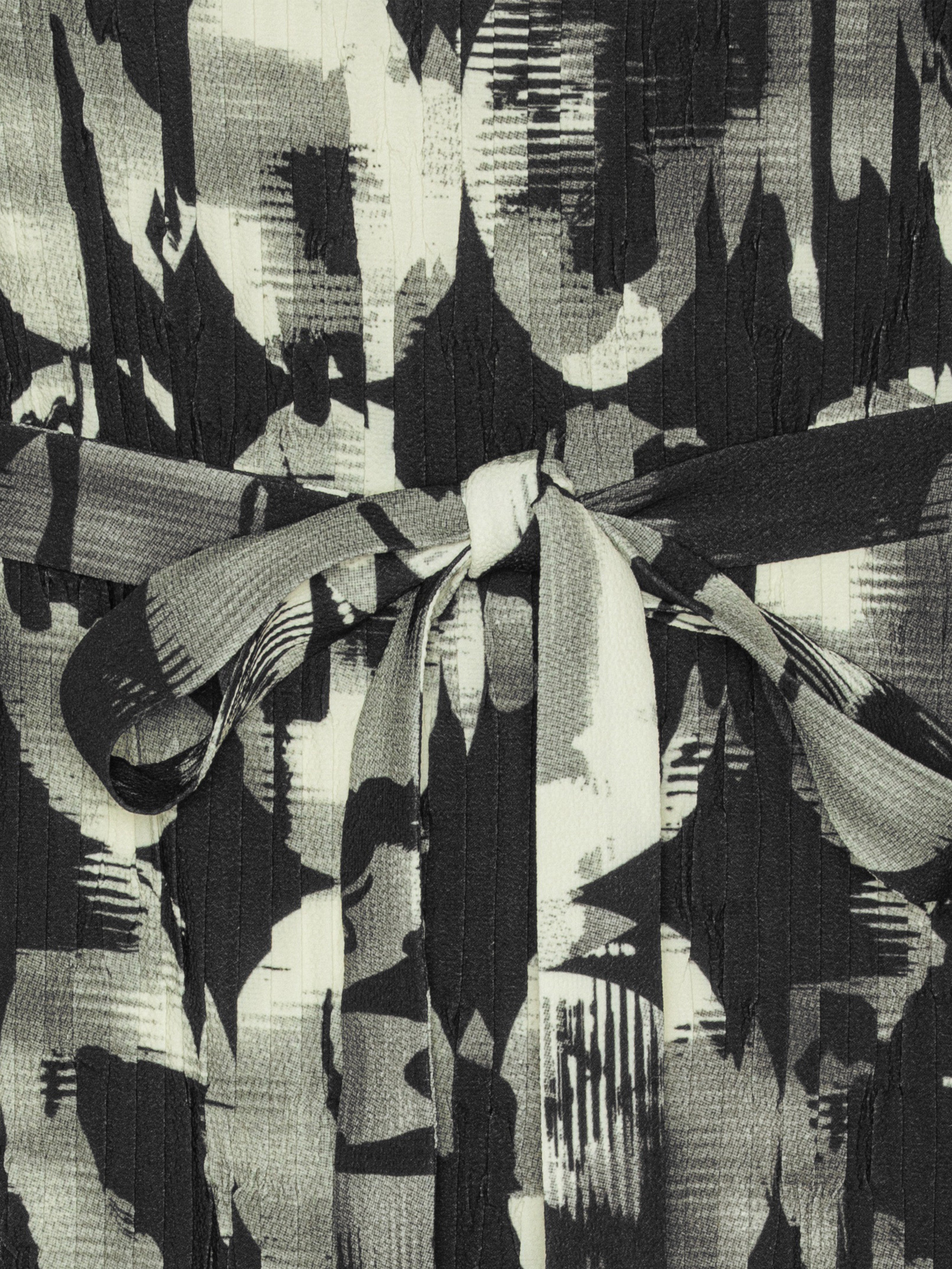 Close-up of the Henrik Vibskov New Pina Plissé Dress in Bursting Eggs, highlighting the abstract egg illustration and pleated plissé texture.
