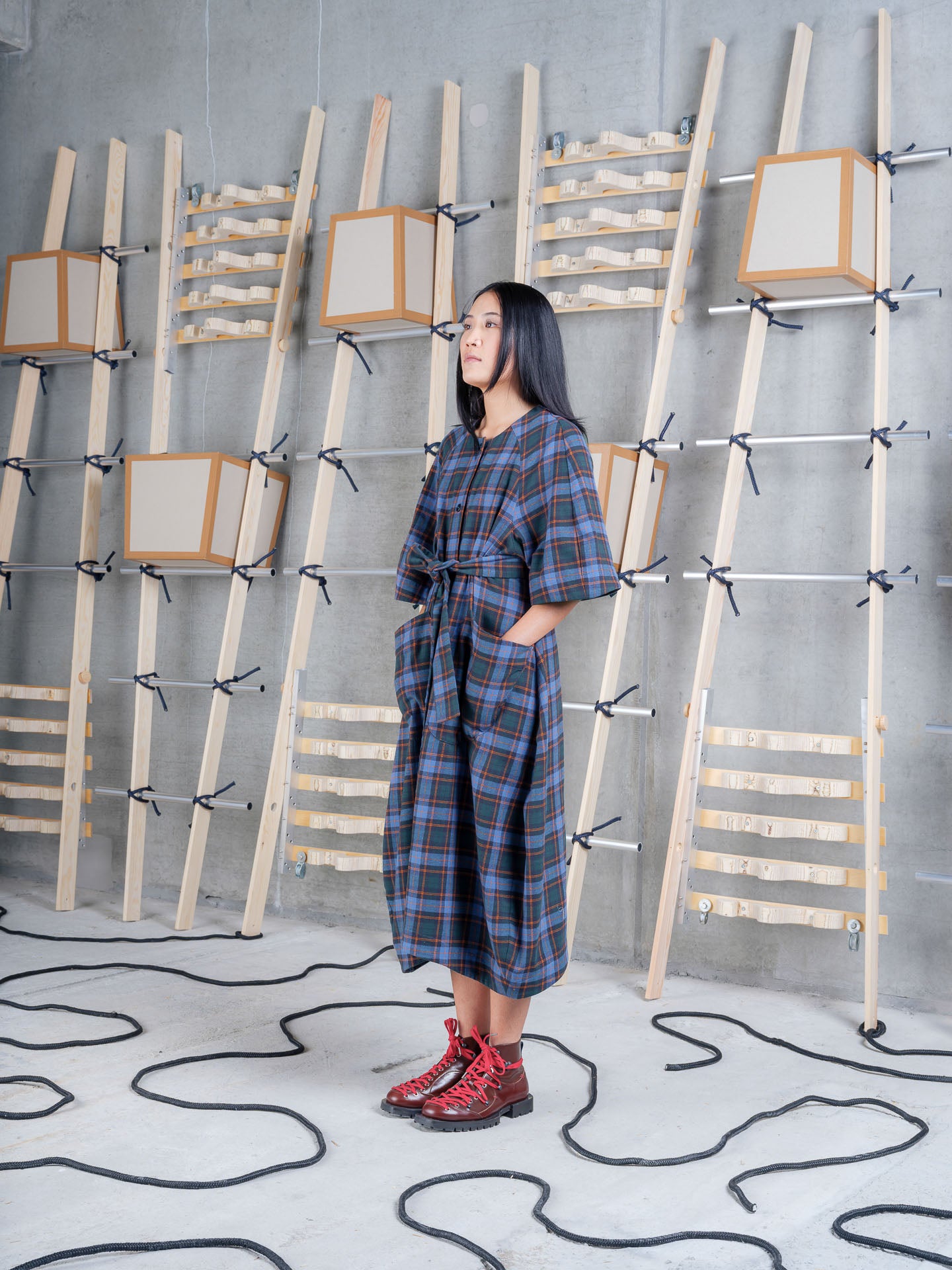 Model wearing the Henrik Vibskov One Dress in Blue Flannel Checks, side view