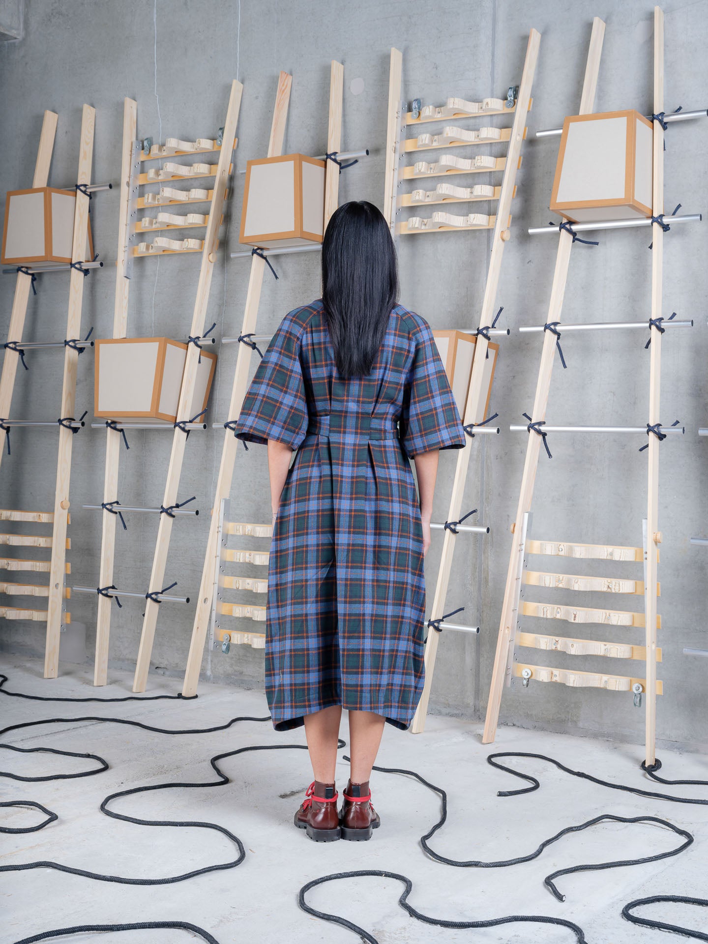 Model wearing the Henrik Vibskov One Dress in Blue Flannel Checks, back view
