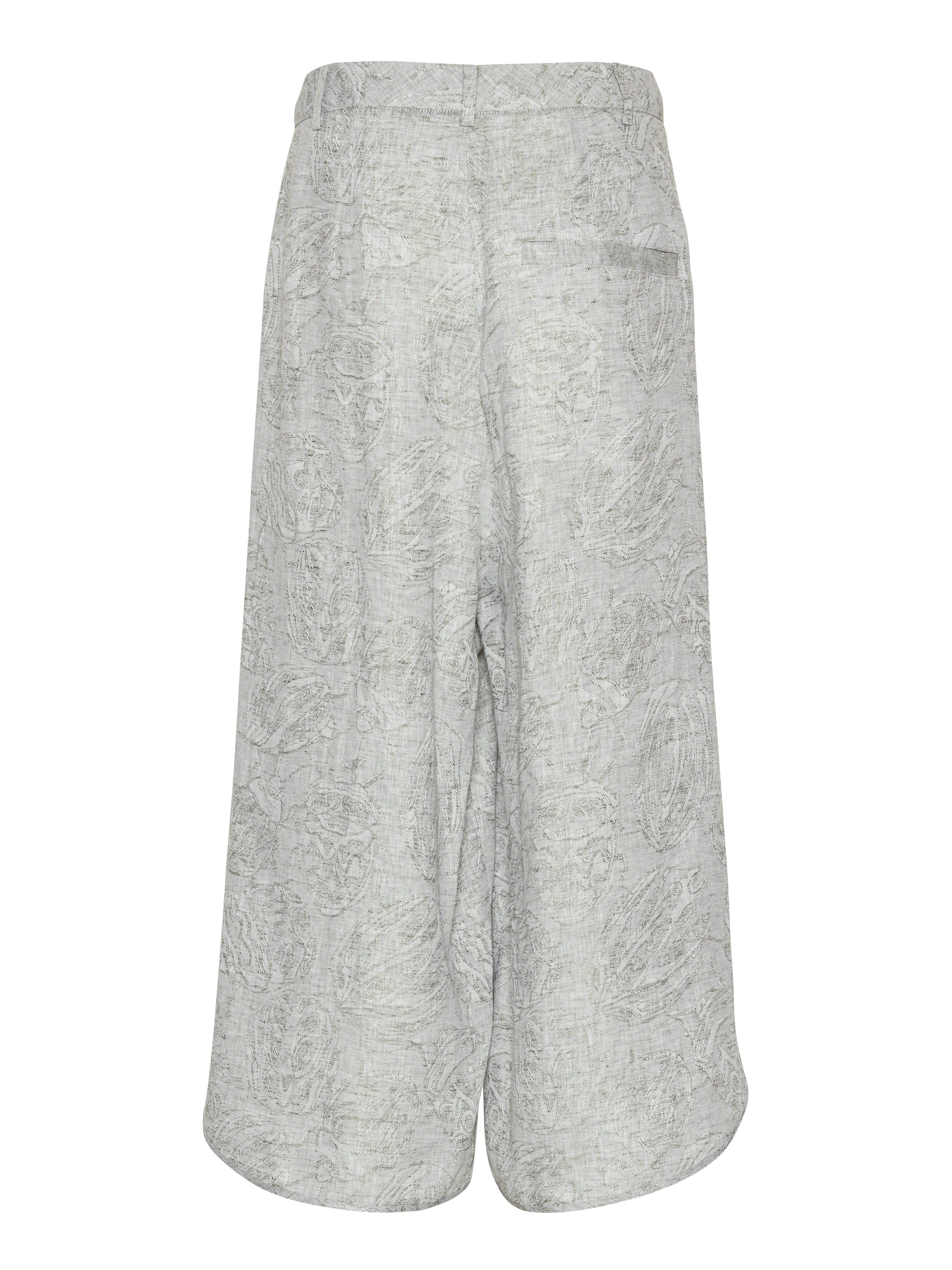 Back view of the Overlap Pants highlighting the wide-leg silhouette and sculptural curved hem.