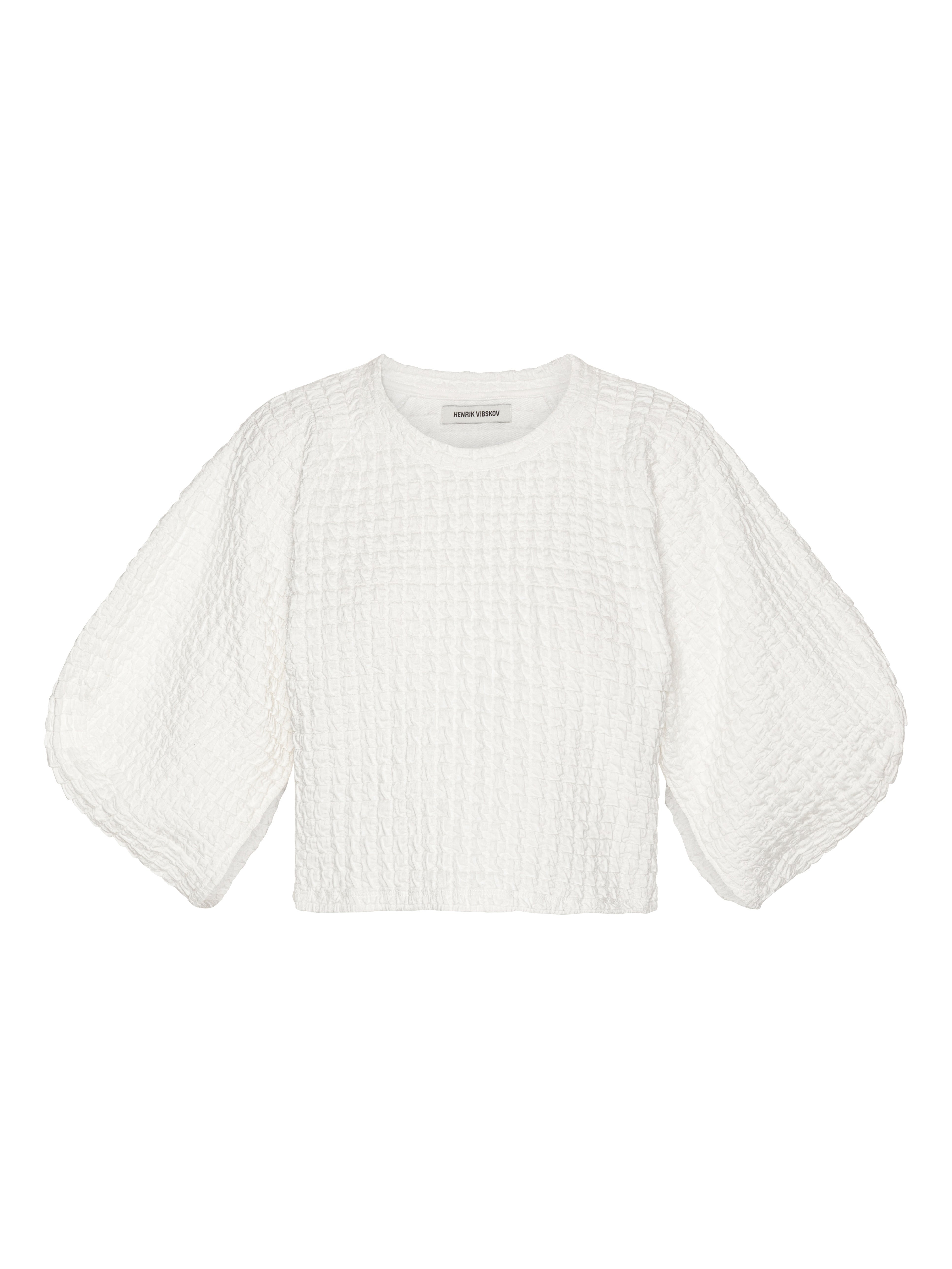 Front view of Henrik Vibskov Persey Top in off-white textured fabric, featuring a round neck, cropped straight hem, and puffy 3/4 sleeves.
