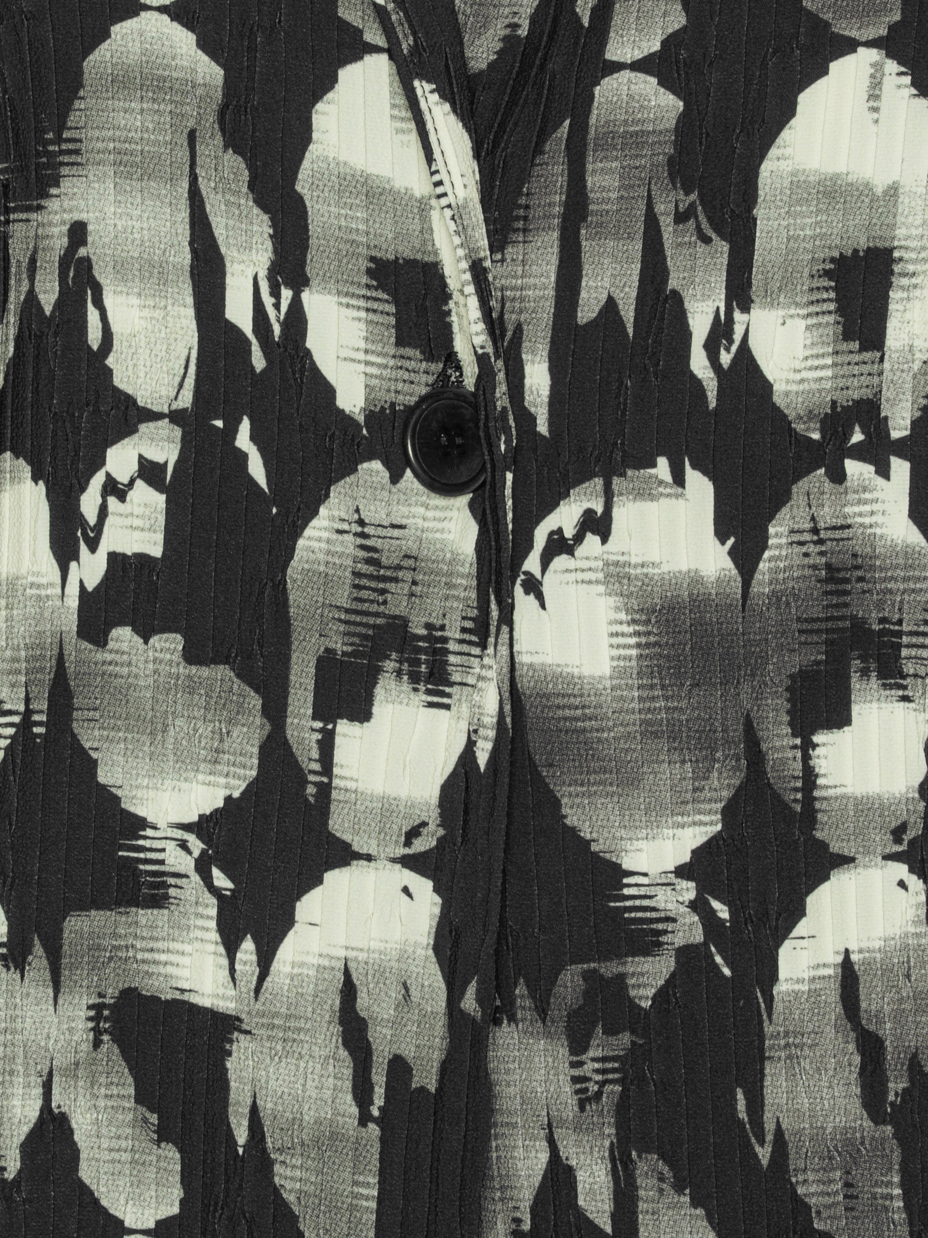 Close-up of the Henrik Vibskov Plissé Blazer in Bursting Eggs, highlighting the abstract egg illustration and pleated plissé texture.