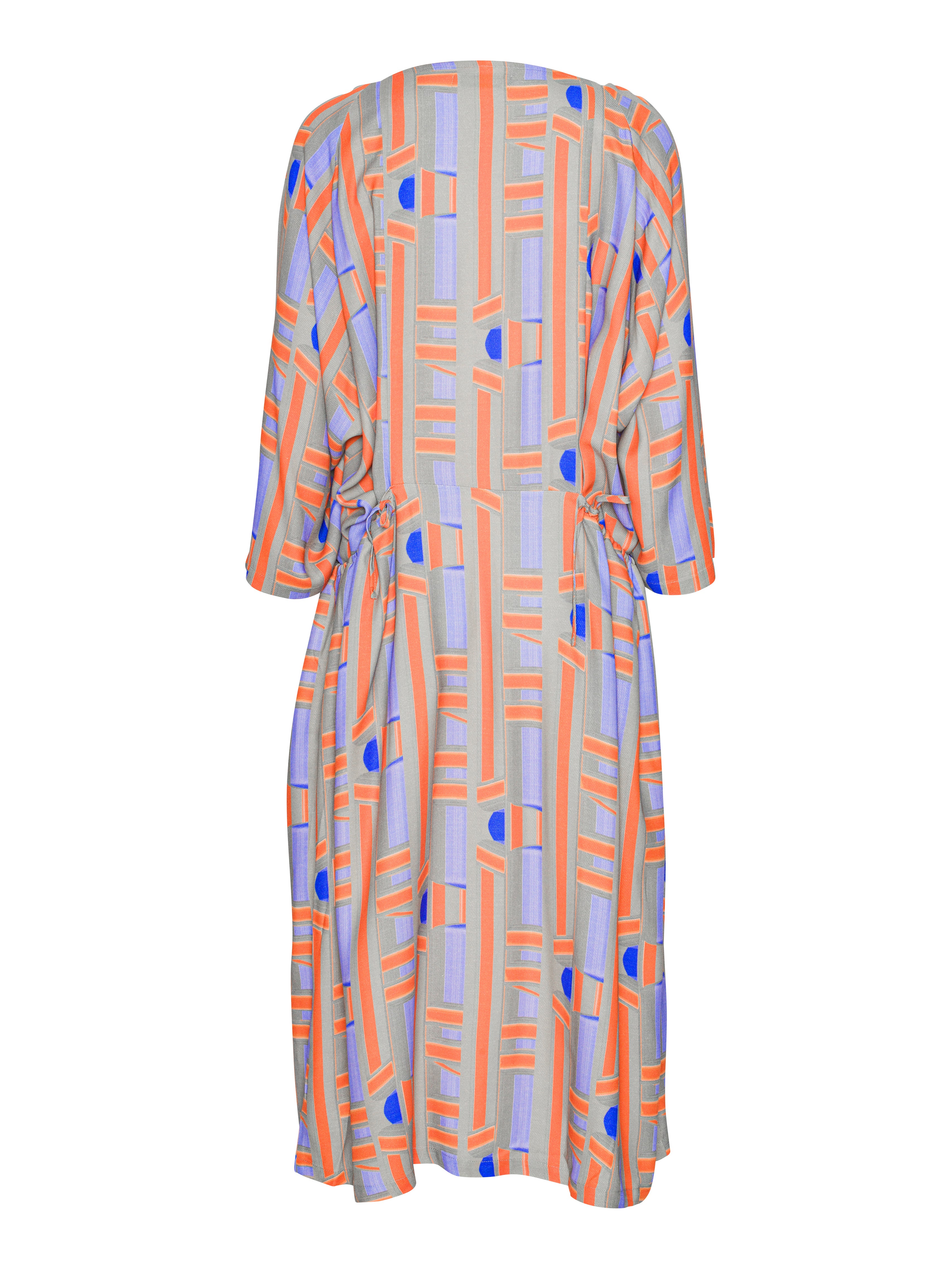 Back side of colorful dress with geometric pattern from Henrik Vibskov on a white background