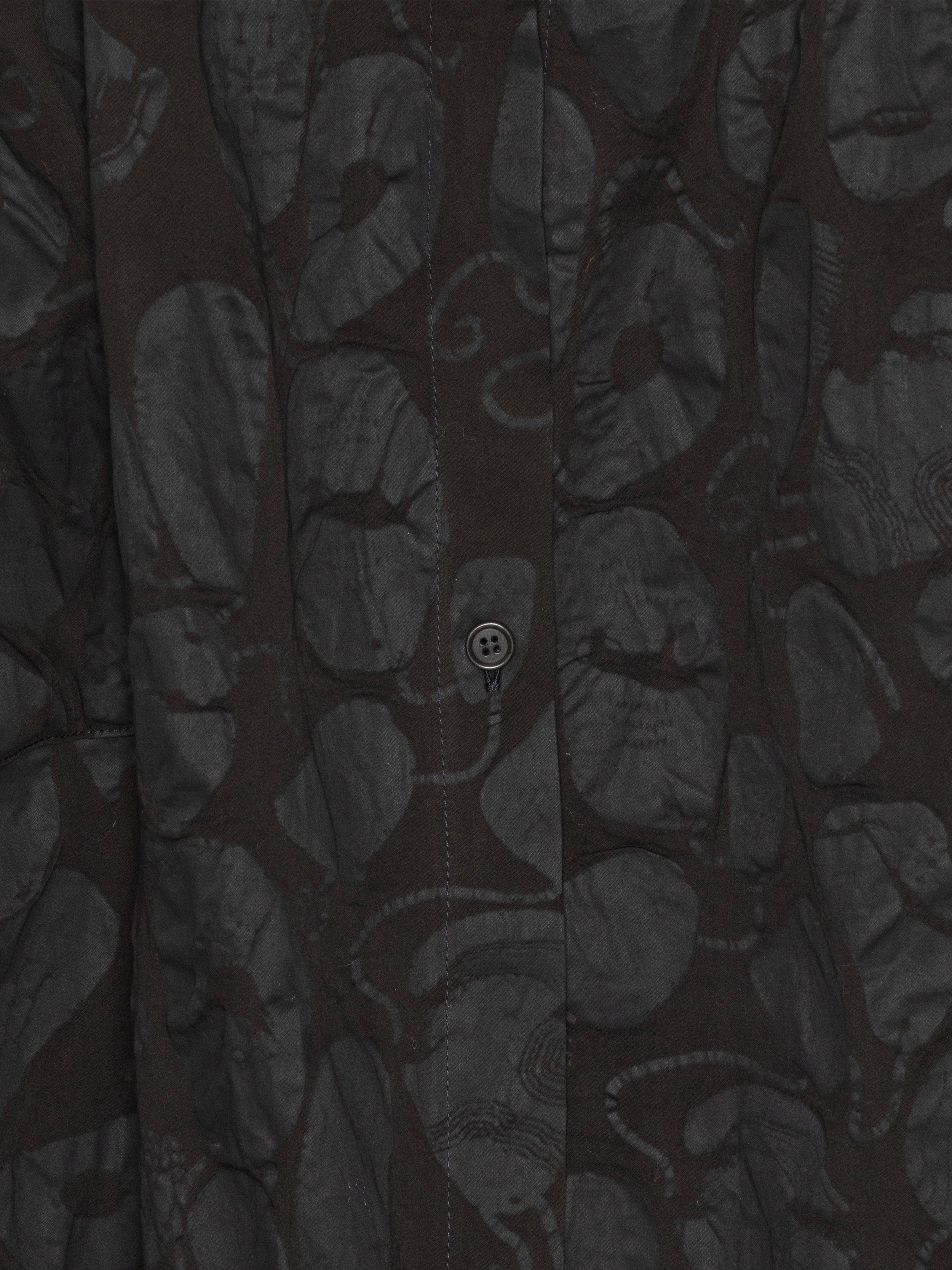Close-up of a black-on-black pattern, sleeveless dress from Henrik Vibskov