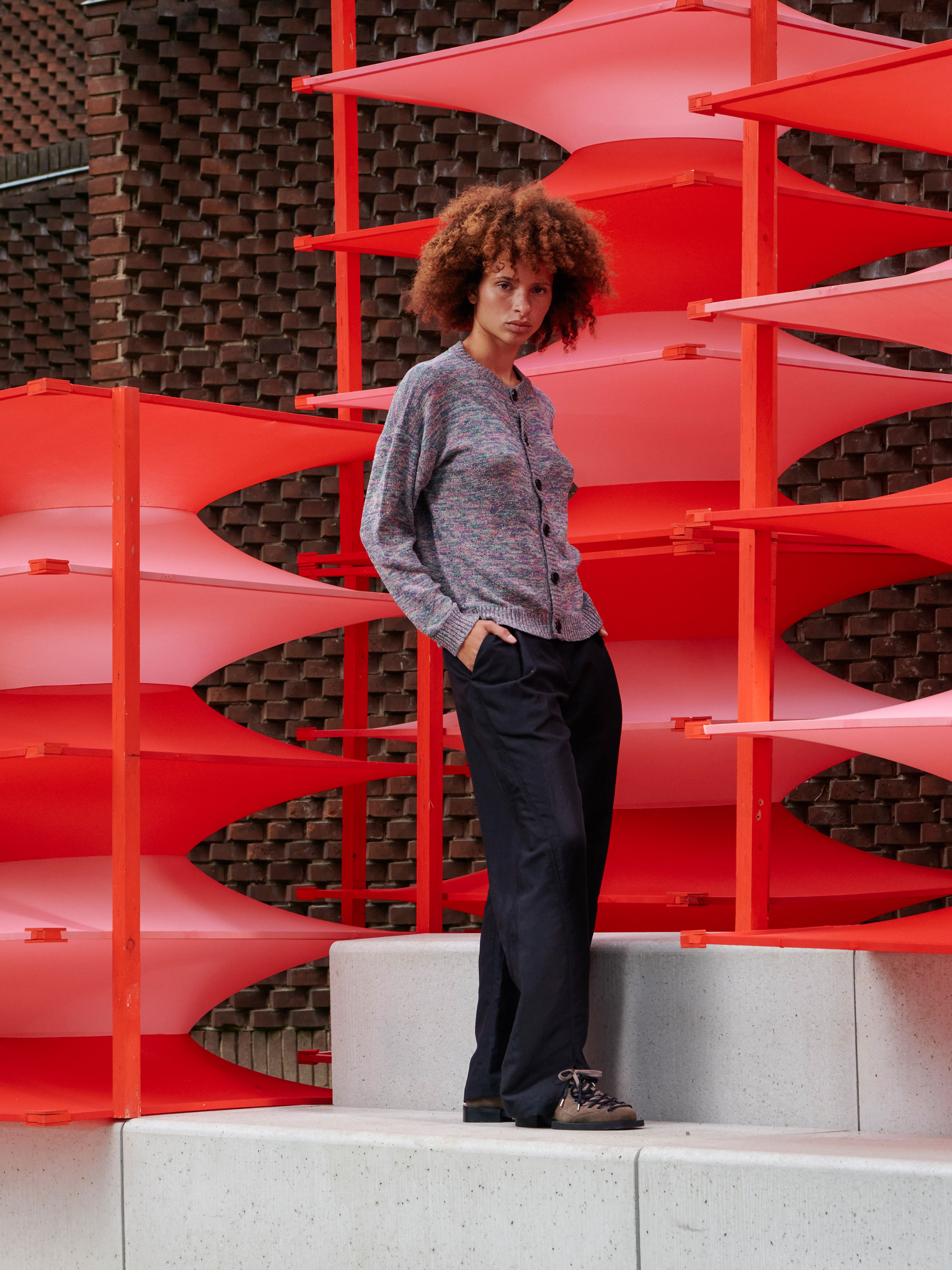 Side view of a model wearing the cardigan, emphasizing the long sleeves and relaxed silhouette.