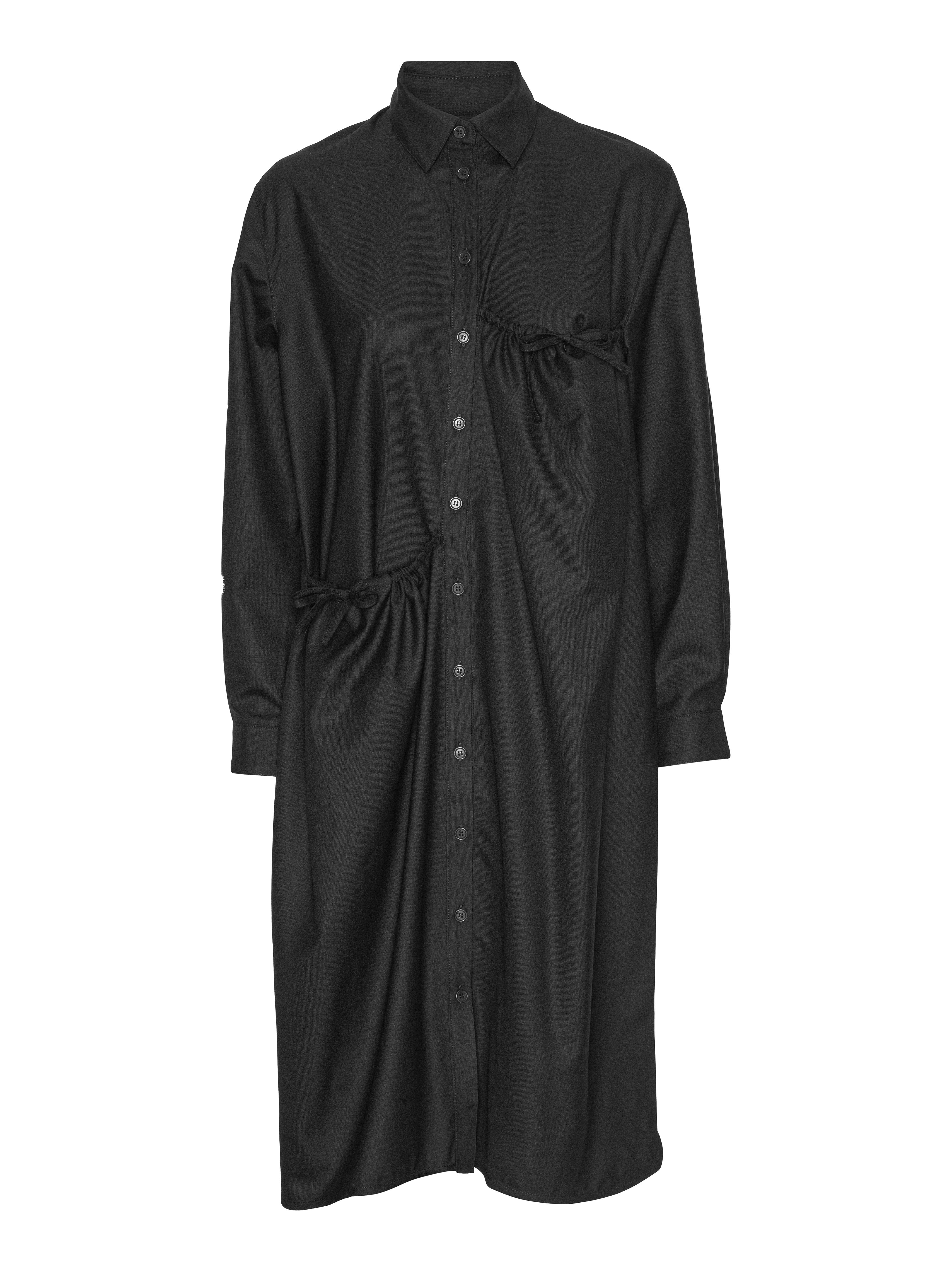 Black shirt dress from Henrik Vibskov on a white background