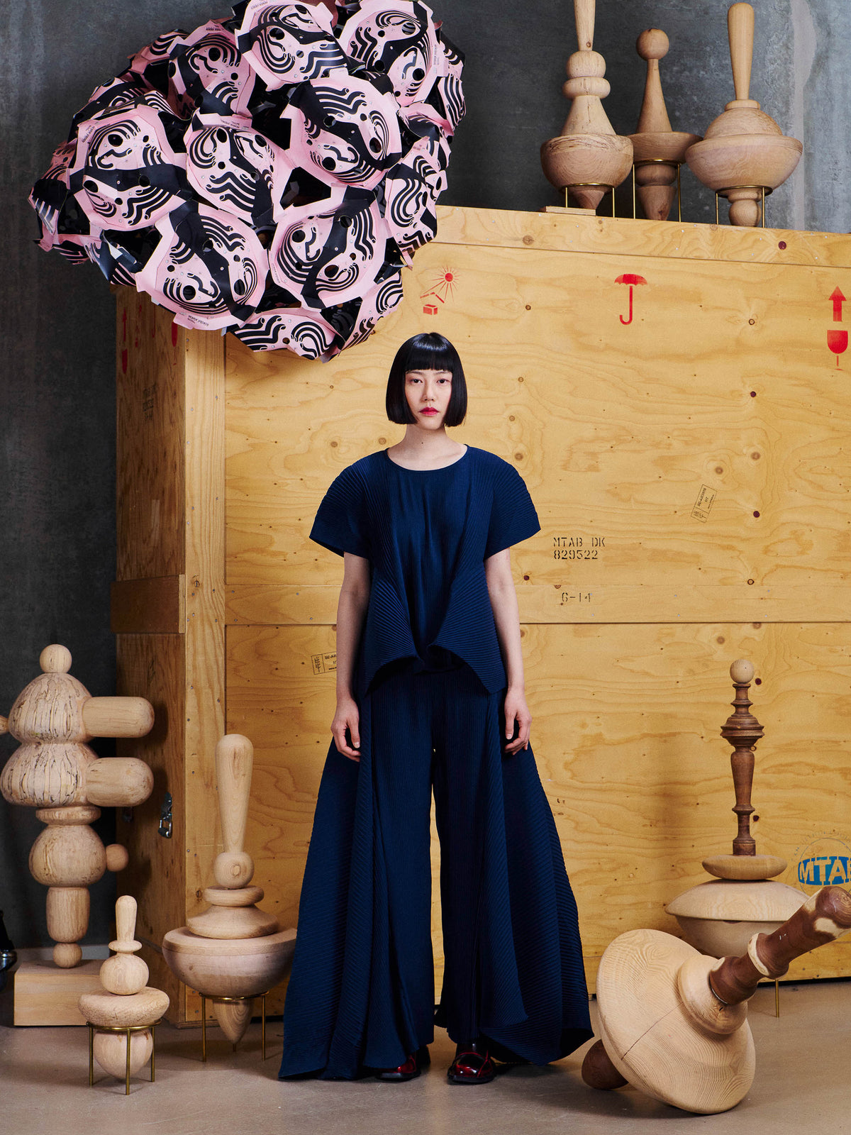 Female model wearing Henrik Vibskov Thumb Plisse Blouse in Dress Blues from the front, showing the relaxed fit and layered pleated construction.