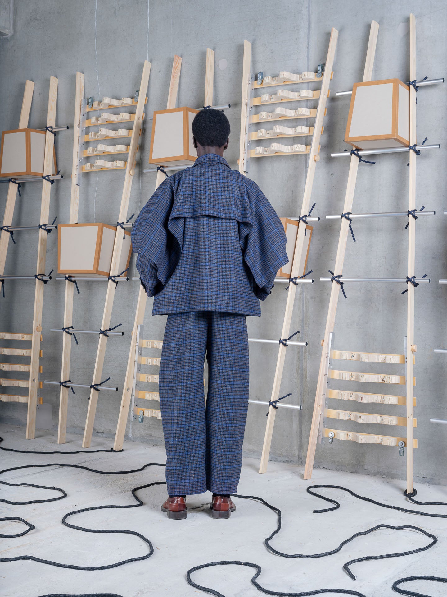Henrik Vibskov Uncut Jacket Blue Wool Checks, model rear view, showing back construction and silhouette