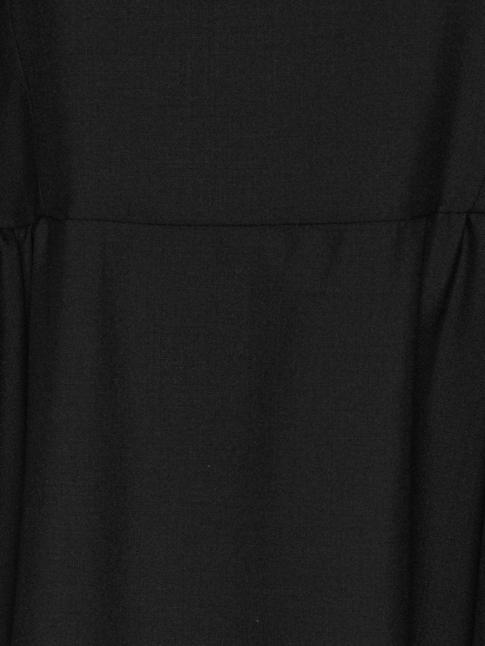 Close-up of Henrik Vibskov Very Turtle Dress in black merino wool showing gathered side panel and soft draped texture