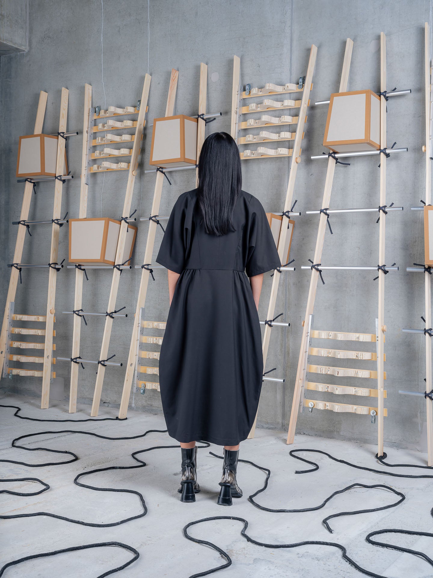Back view of Henrik Vibskov Very Turtle Dress in tropical black merino wool with loose fit and sculptural draped shape